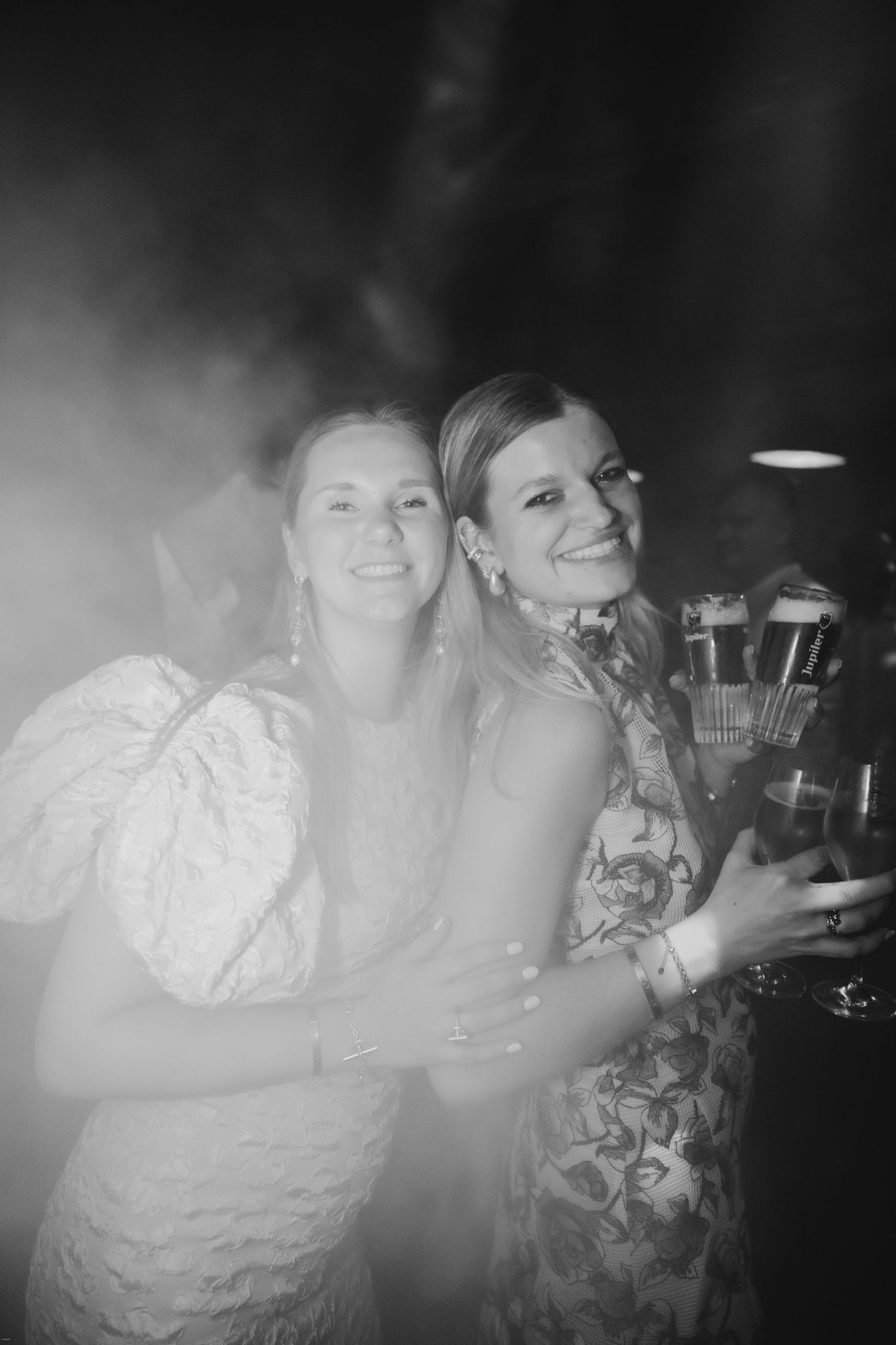 Black and white photo of guests enjoying themselves at a lively party celebration.