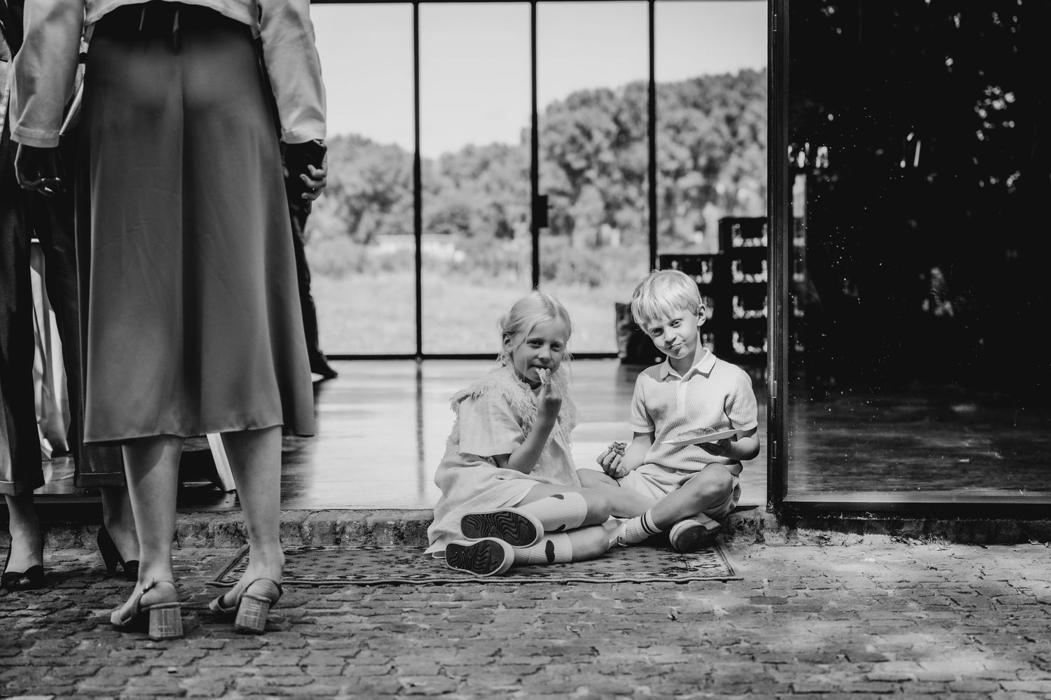 Black and white photo of guests enjoying an outdoor garden party.