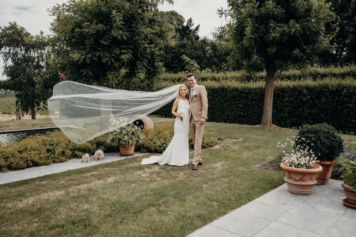 Panoramic view of an outdoor wedding venue with garden and natural landscape.