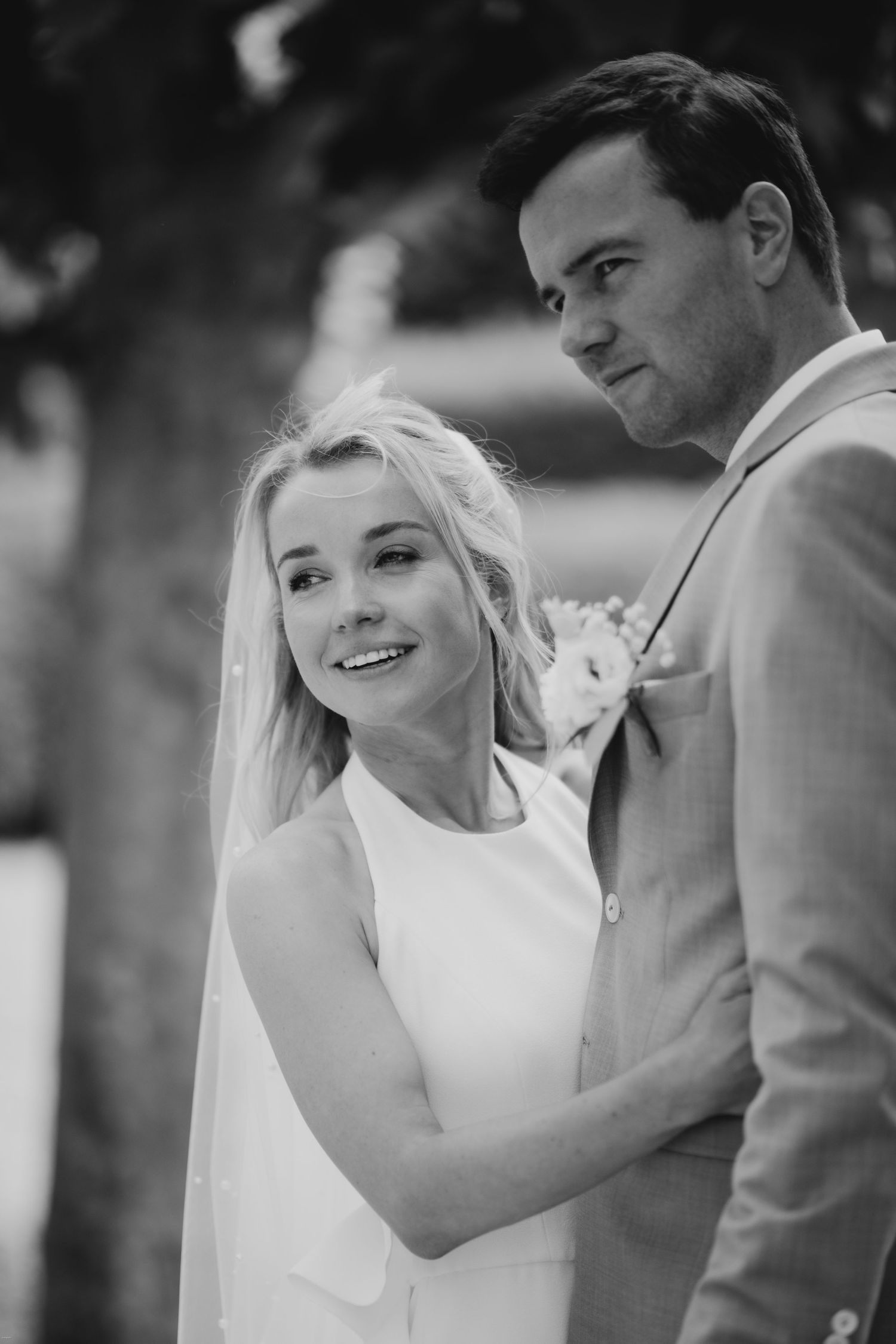 Artistic black and white wedding portraits showing tender moments between newlyweds.