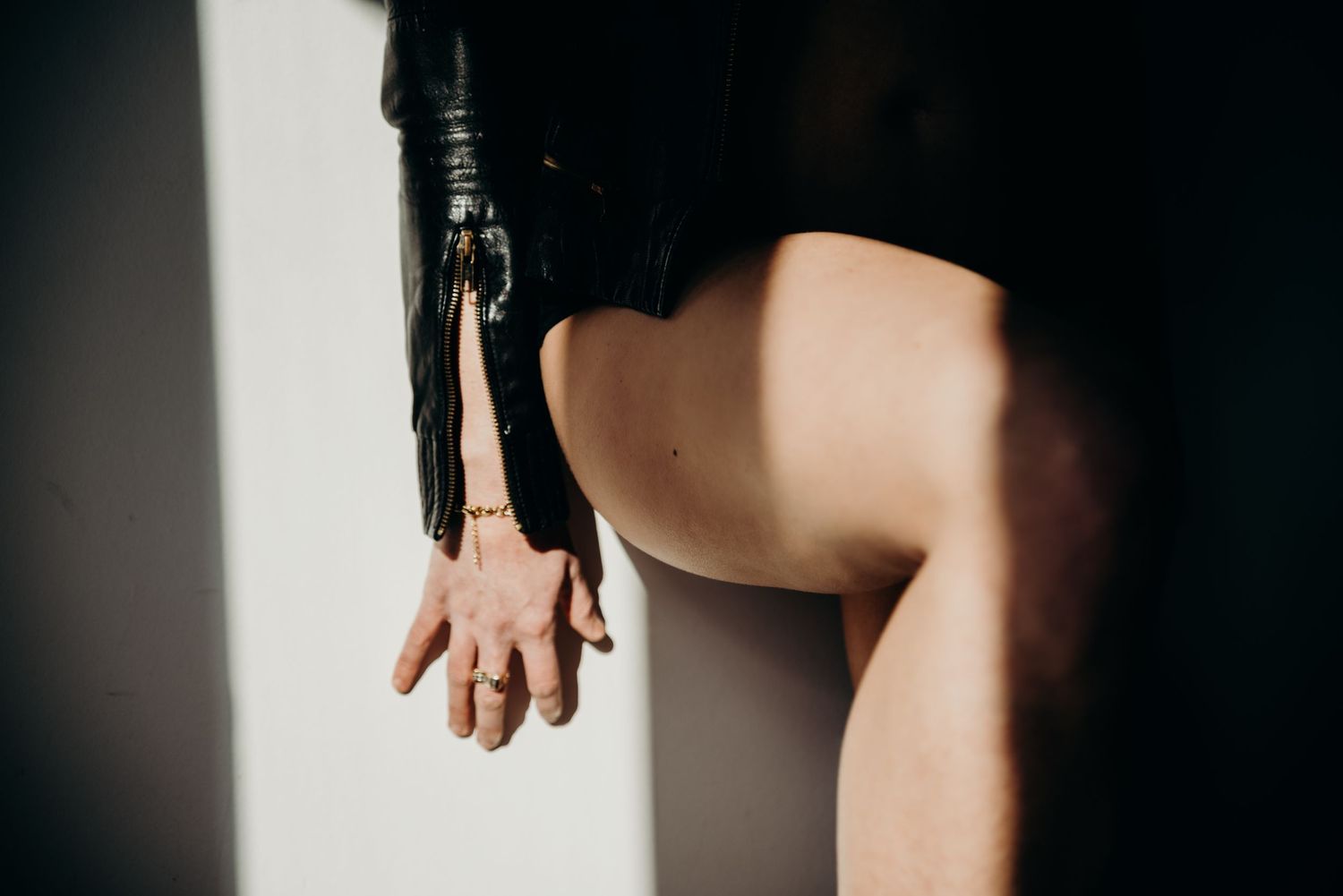A dark and moody portrait series showing close-up details of a person against a black background.