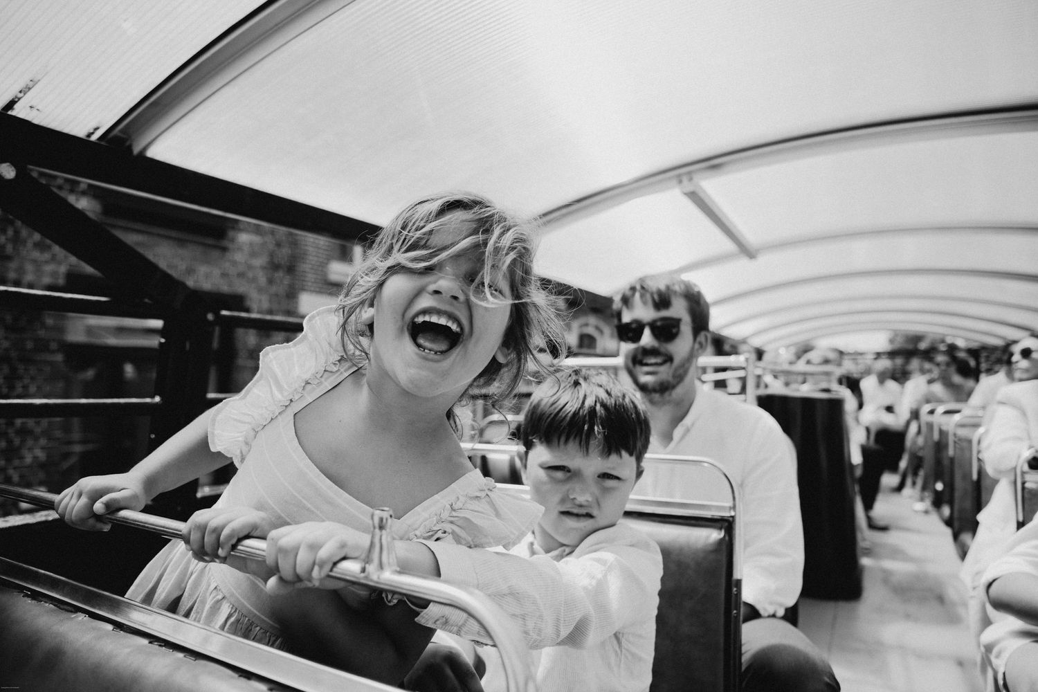 Black and white photo sequence showing joyful laughter and candid moments in a car.