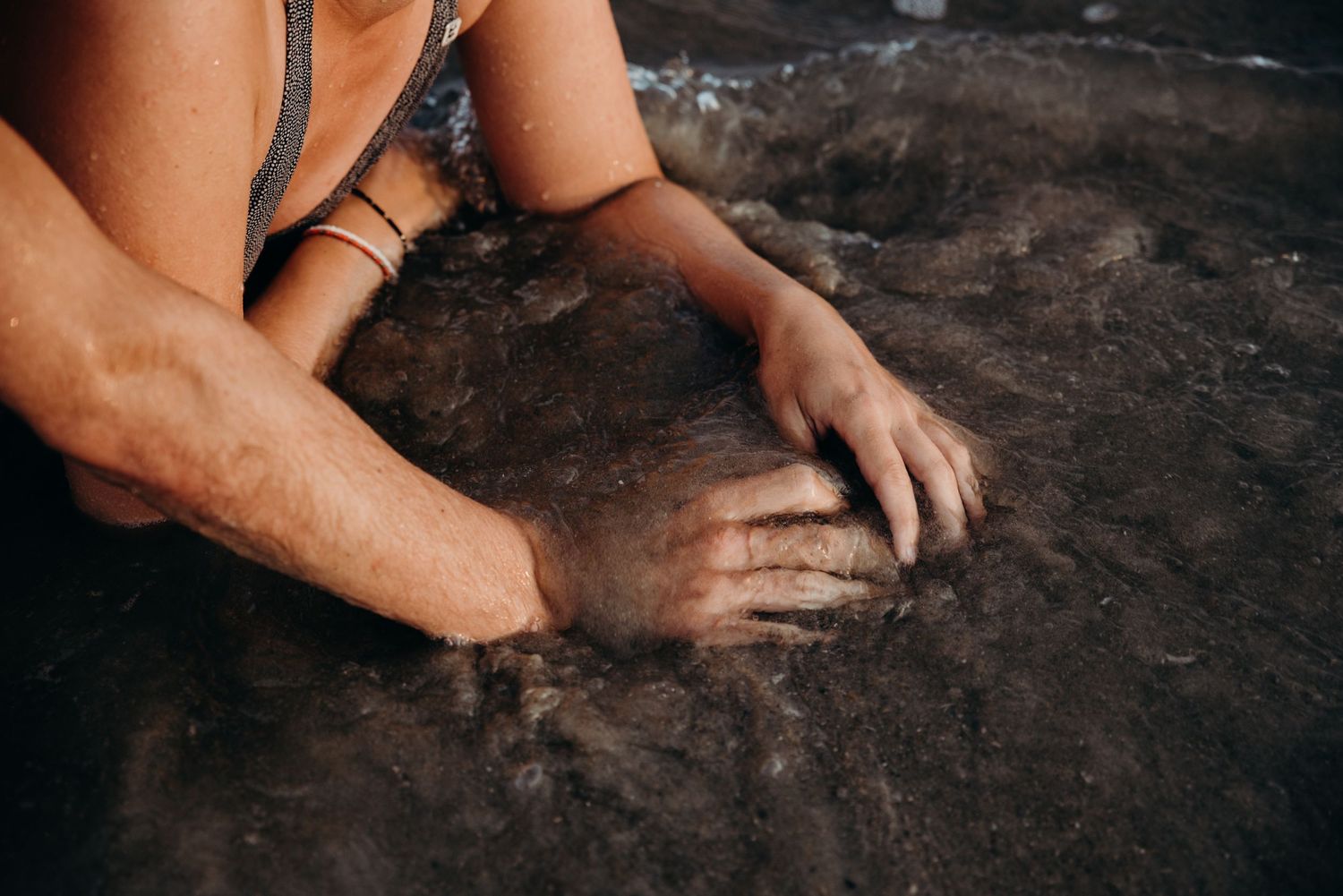Close-up view of hands working with clay on a pottery wheel, shaping and molding the material with skilled precision.