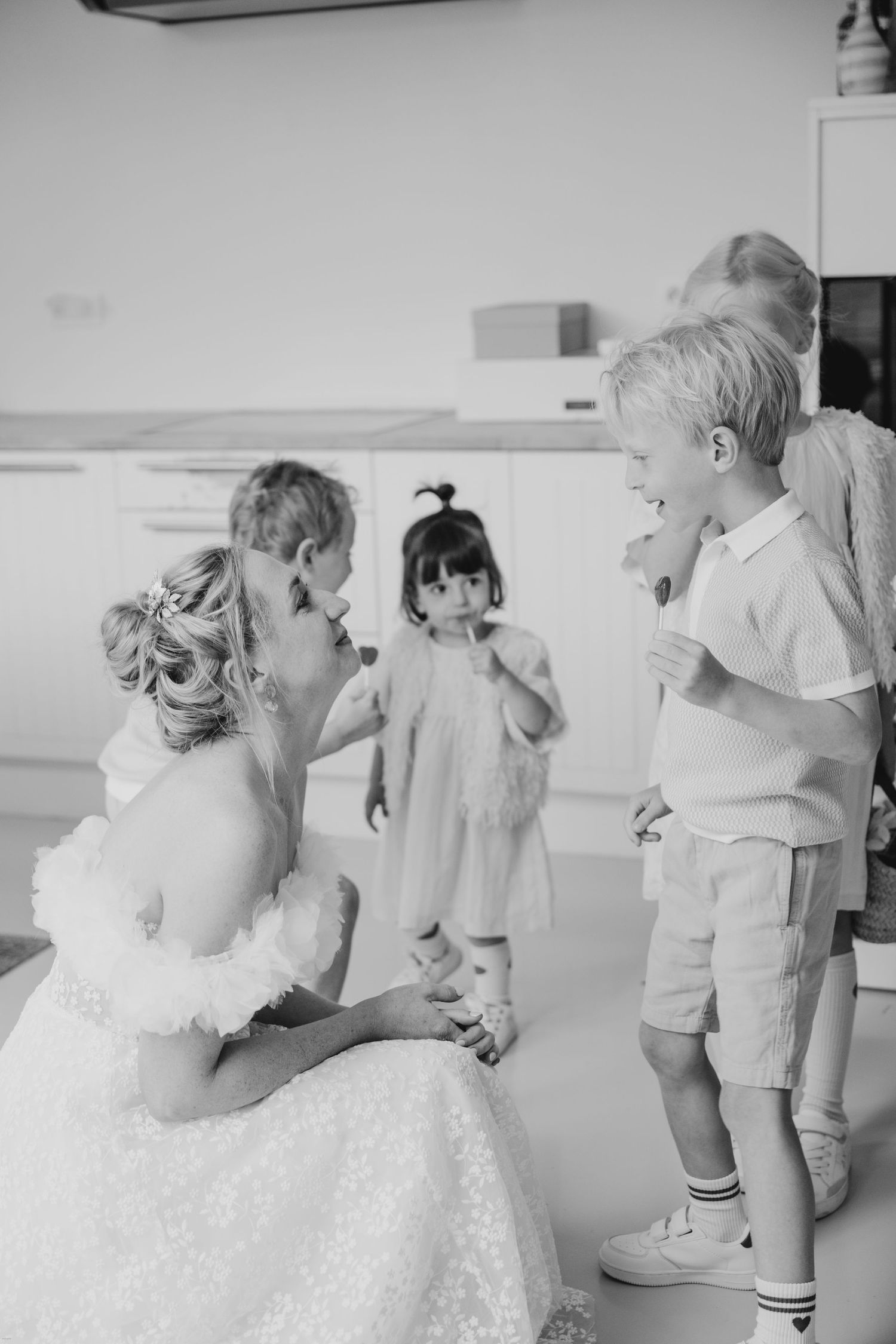 A sweet moment captured in black and white during a wedding celebration.