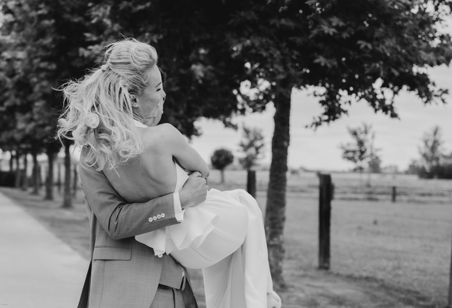 Black and white wedding photos arranged in a series showing intimate moments in an outdoor garden setting.