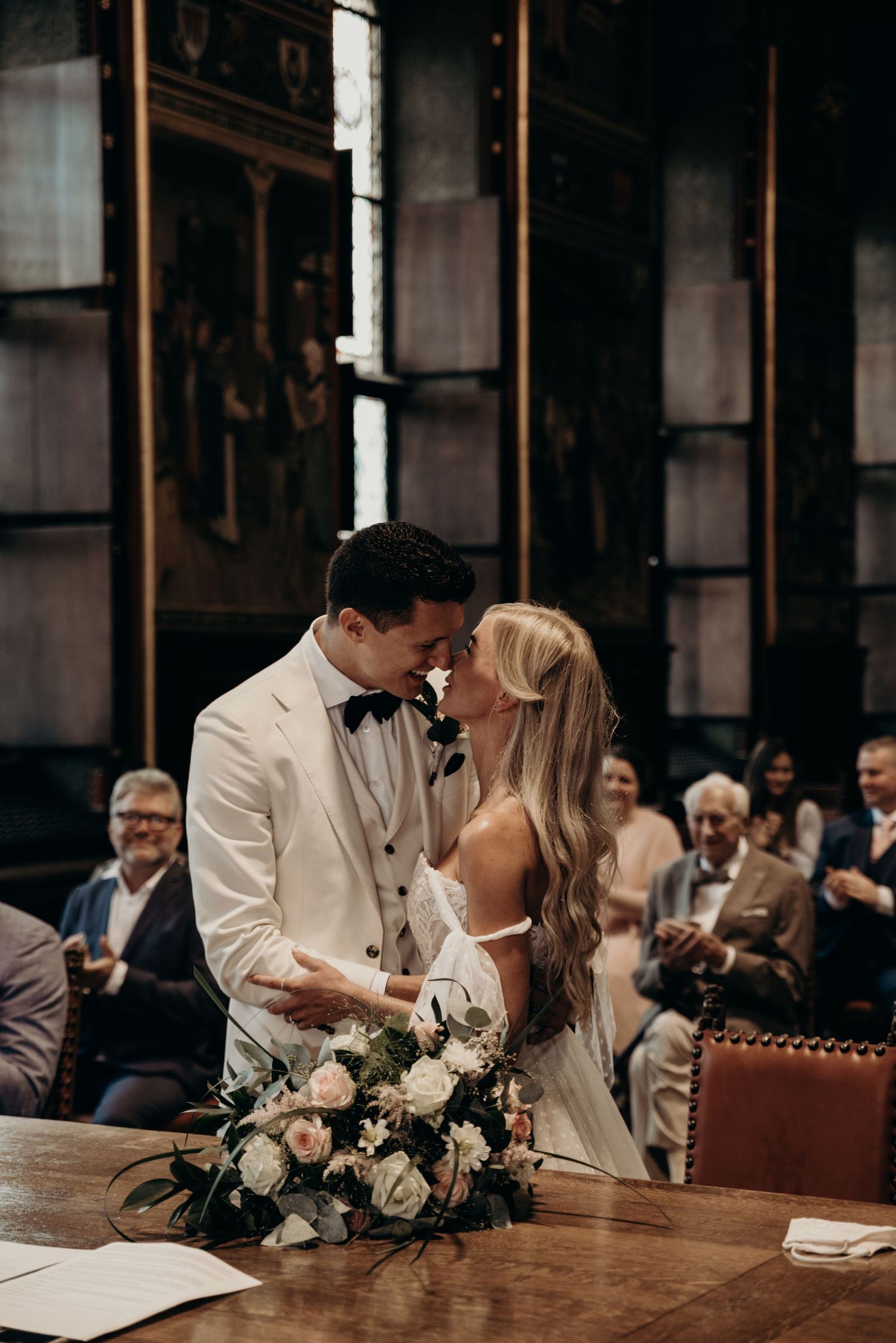 Romantic wedding ceremony in a rustic indoor venue with wooden details.