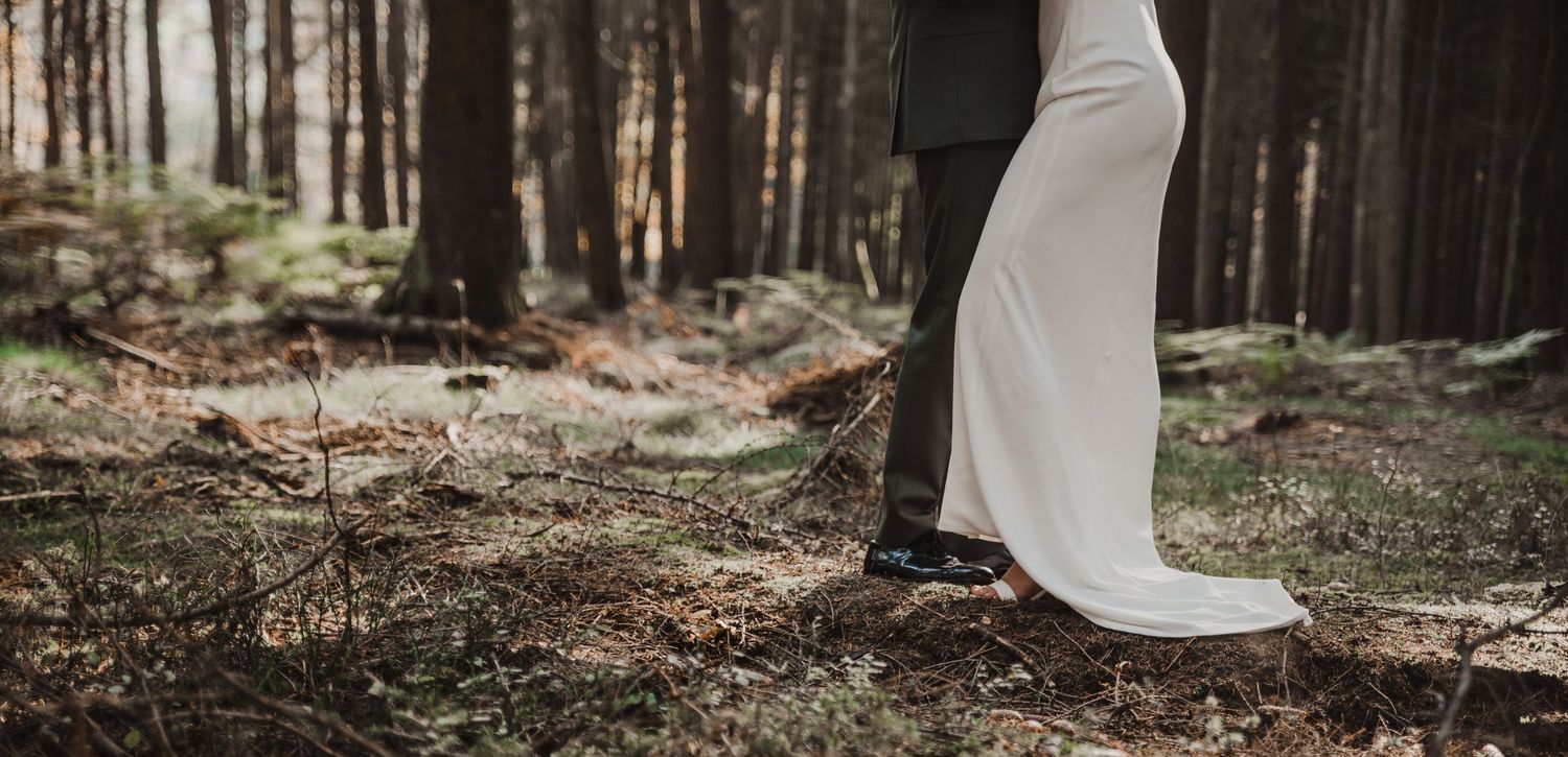 Flowing white dress captured in motion through a forest setting.