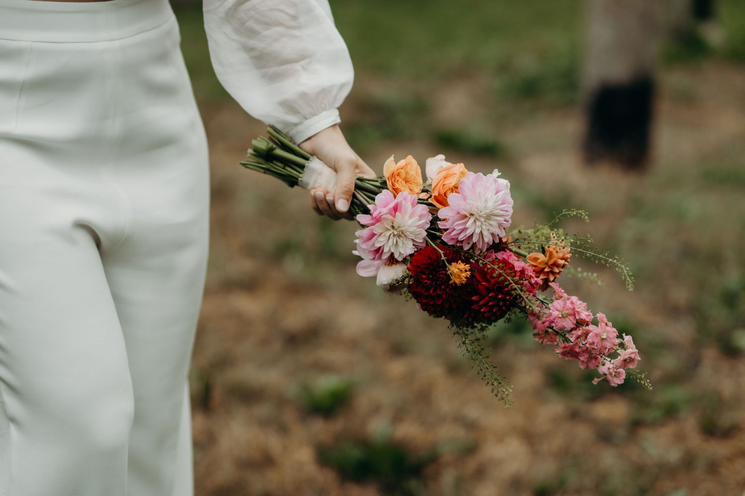Close-up of colorful wedding bouquet with pink and peach flowers.