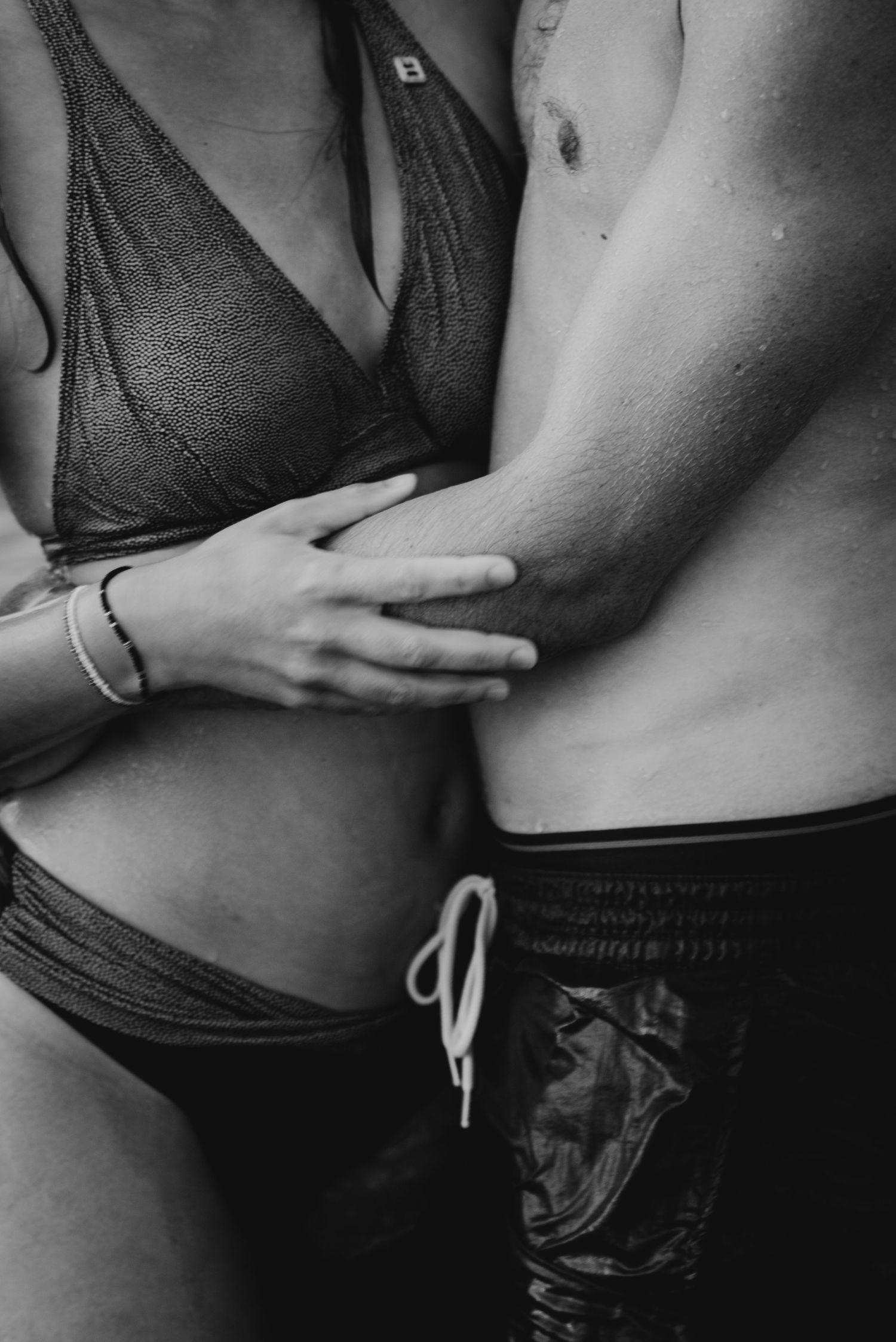 Black and white artistic series showing close-up views of a woman's torso in athletic wear.