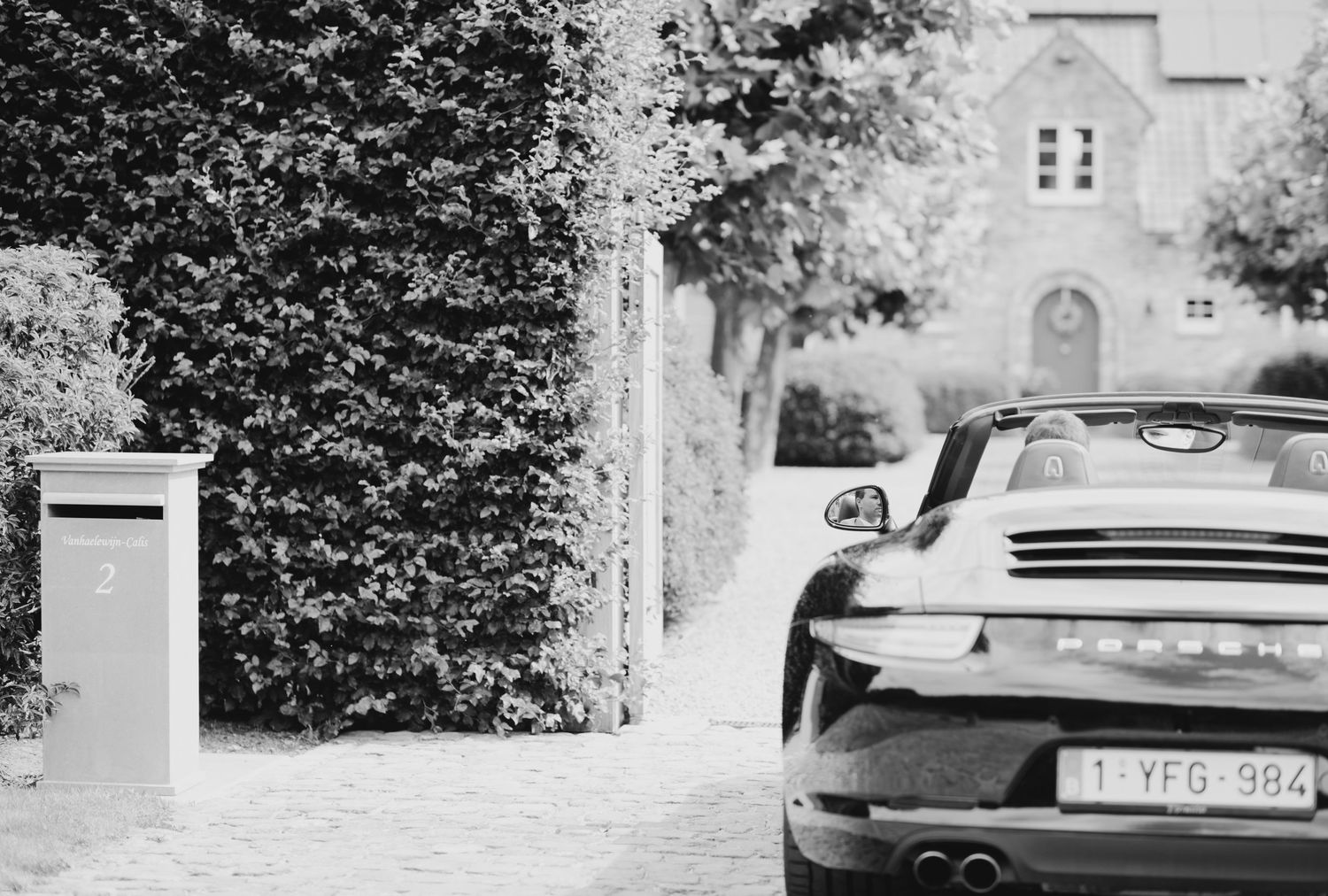 Vintage cars parked outside a building in black and white photography.