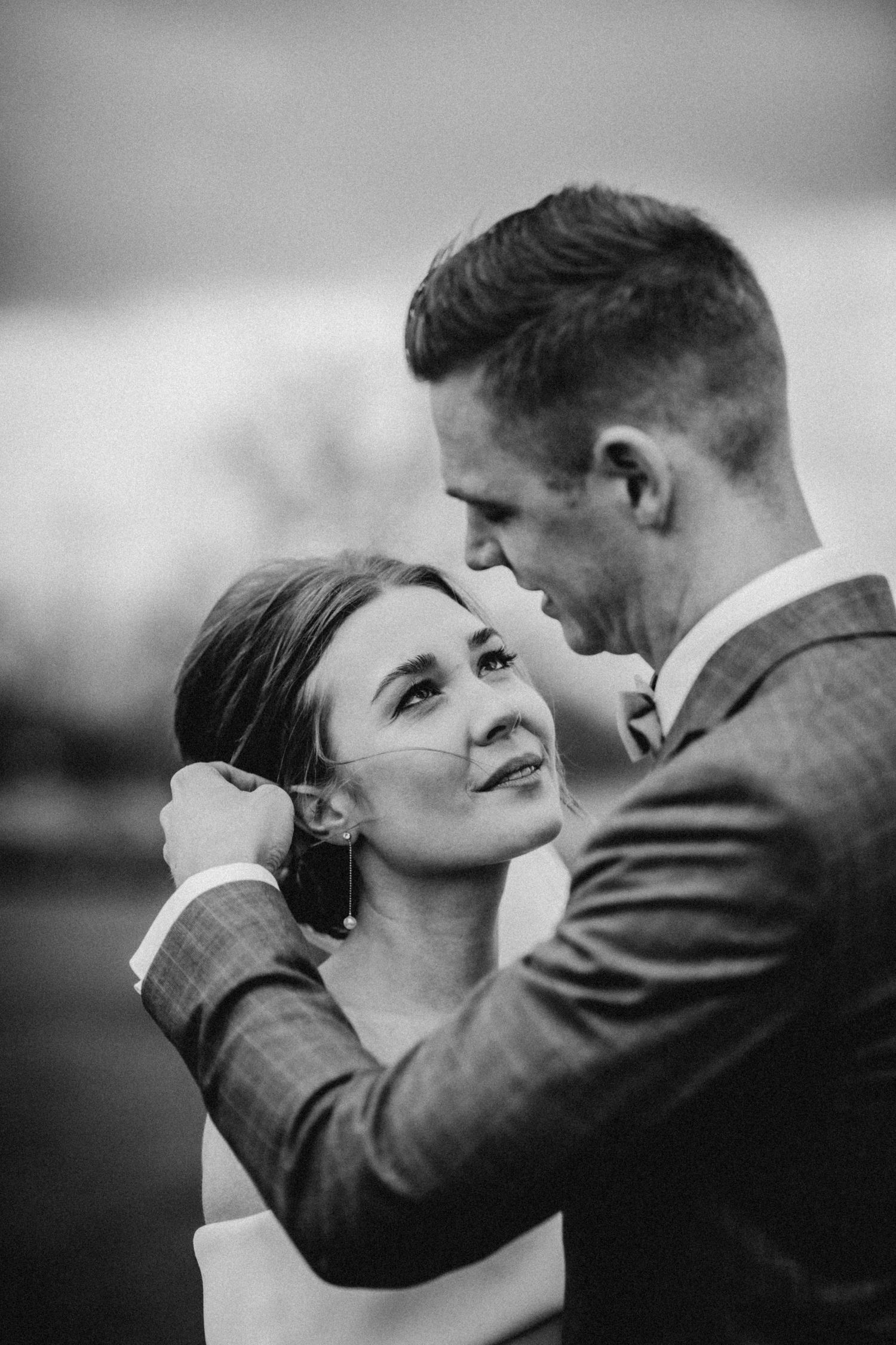 Intimate black and white portrait of a romantic wedding couple moment.