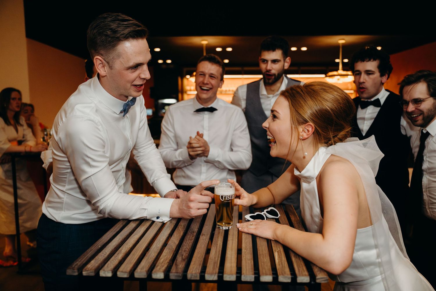 Wedding guests engaged in an energetic party game at the reception.