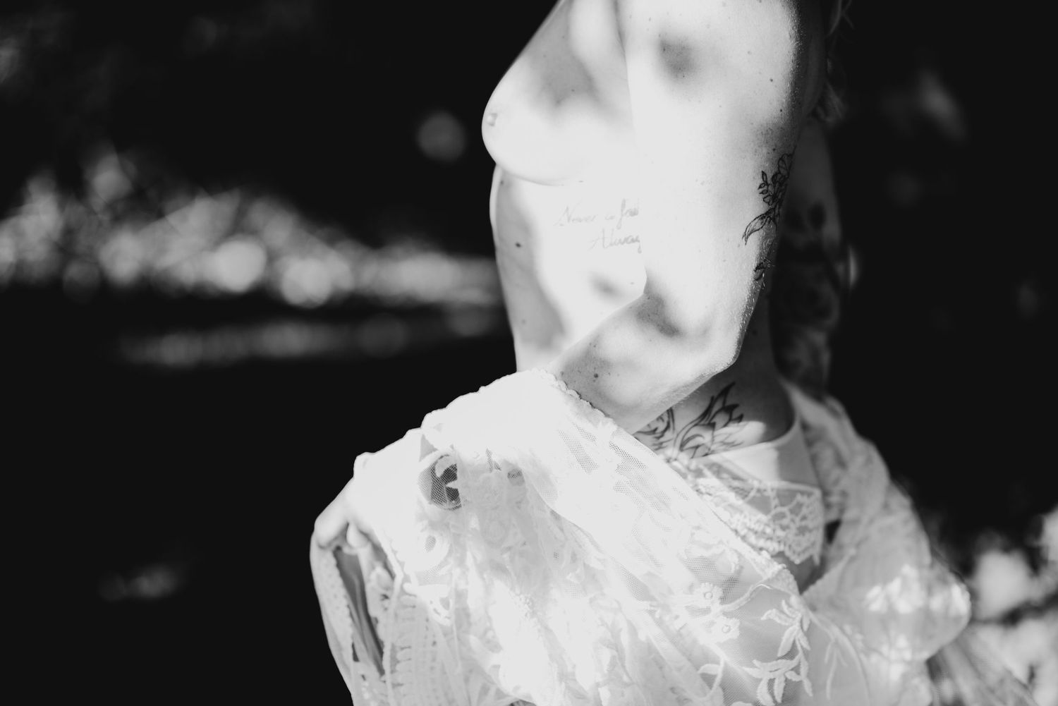 Artistic black and white portrait showing smoke and ethereal fabric creating a dreamy, mysterious atmosphere.