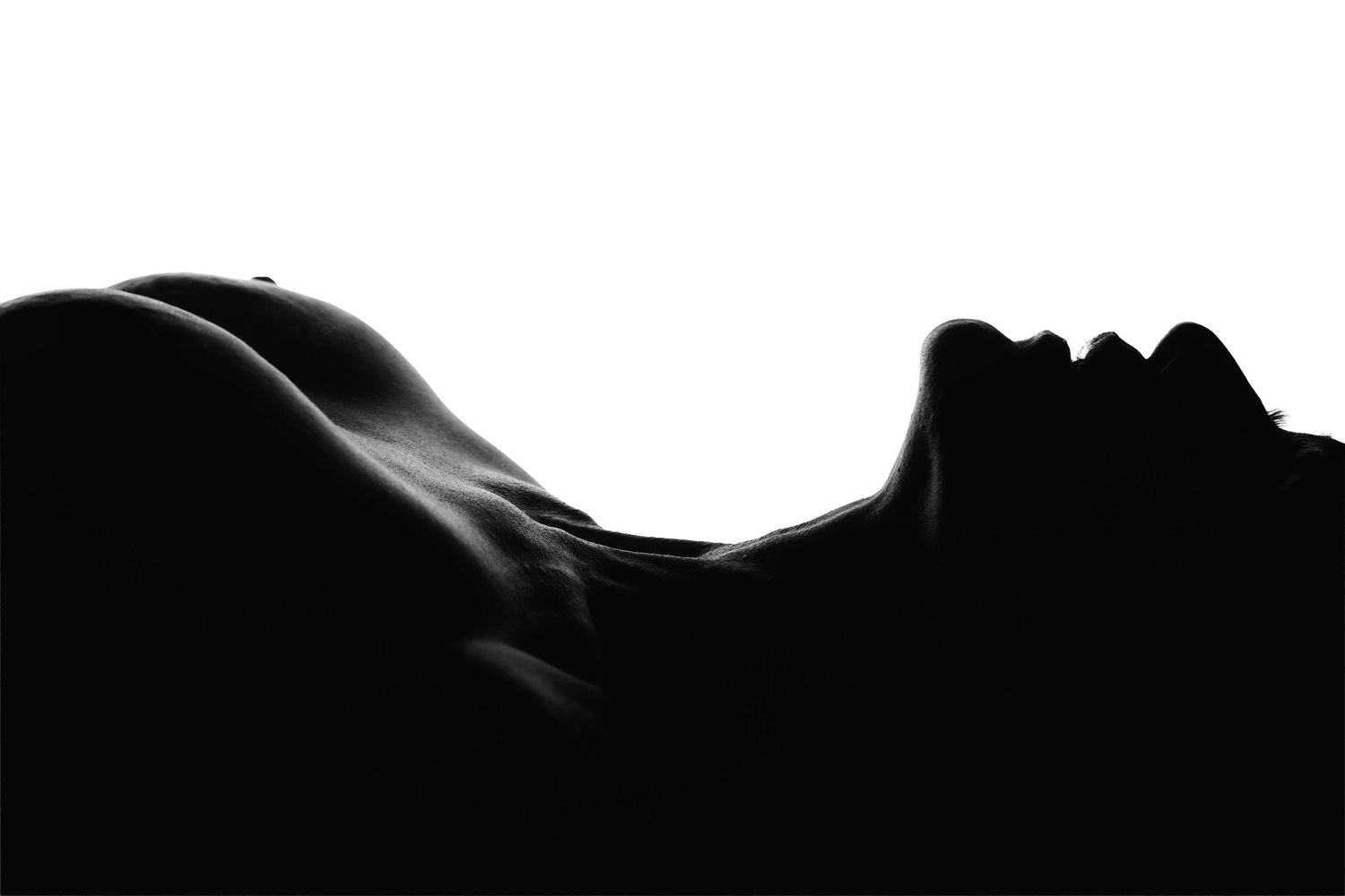 Luxury Charlotte boudoir photography with guided posing and editorial lighting of a woman's silhouette.