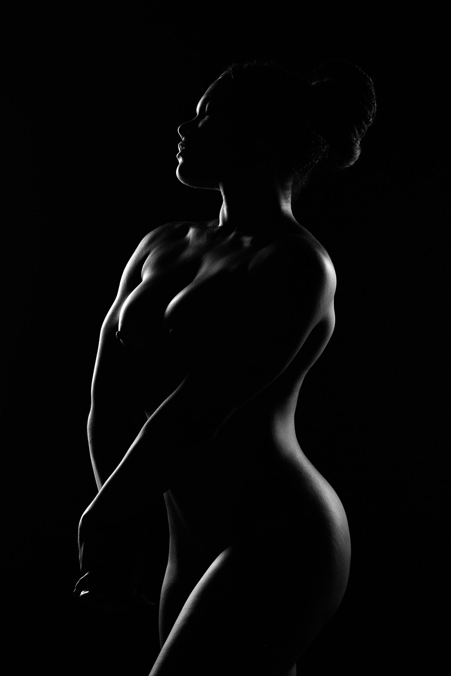 Luxury editorial boudoir portrait in North Carolina showcasing cinematic lighting and erotic posing.