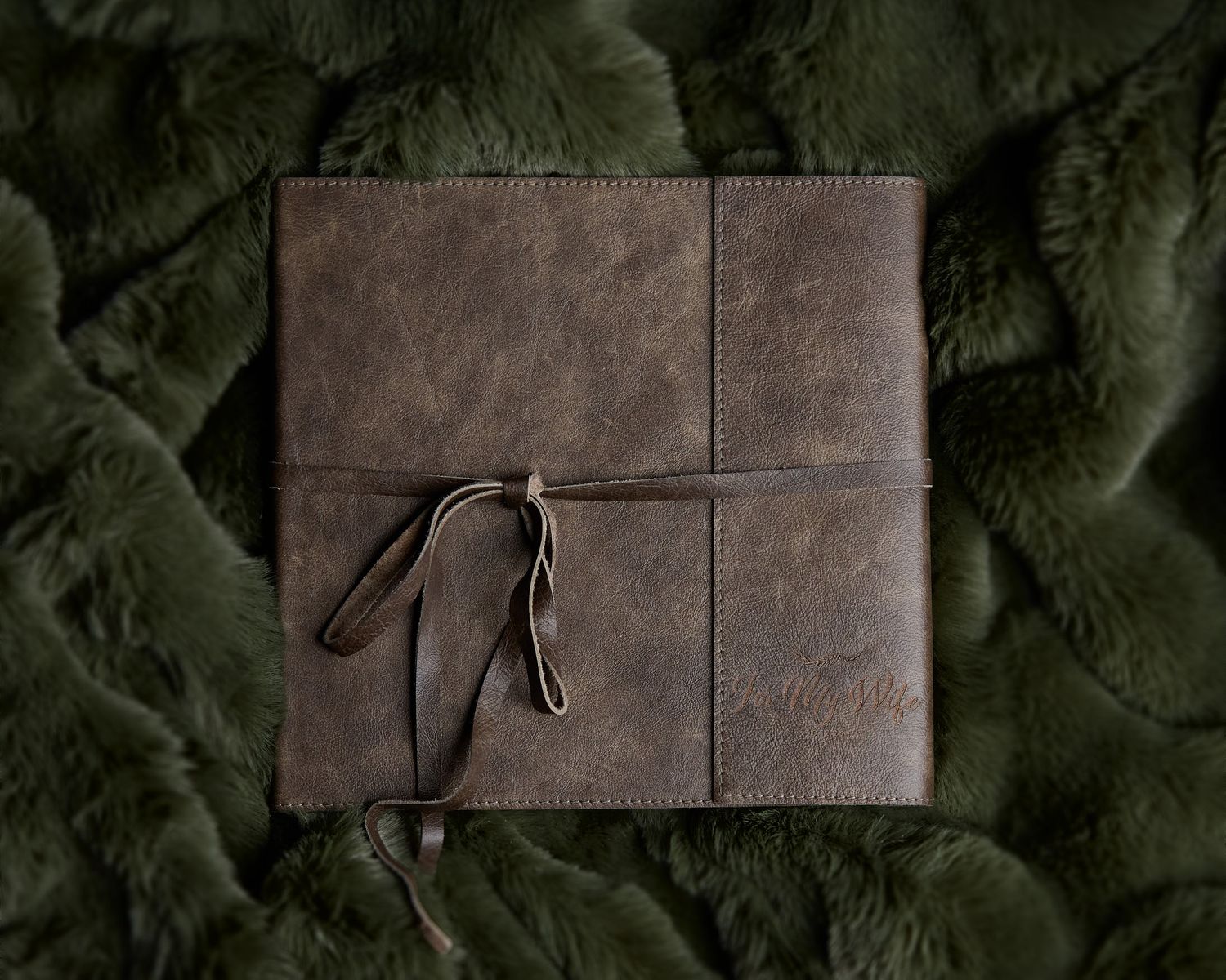 Hand-stitched leather journal-style boudoir photo book with fine art paper, a premium heirloom product for luxury photography sessions.