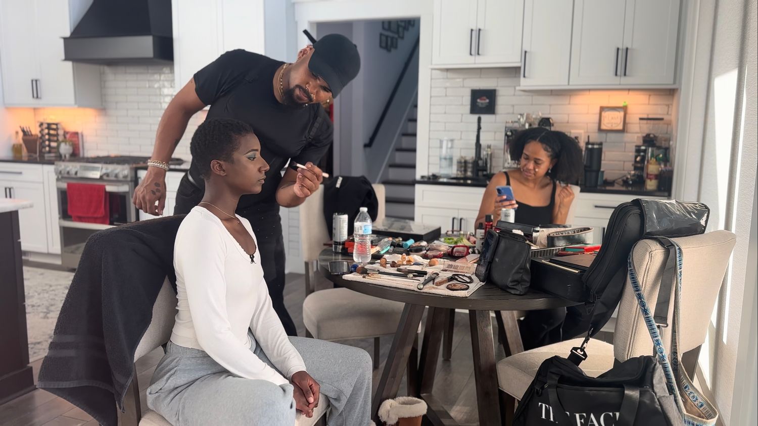 Makeup artist applying makeup to a boudoir client for her boudoir session.