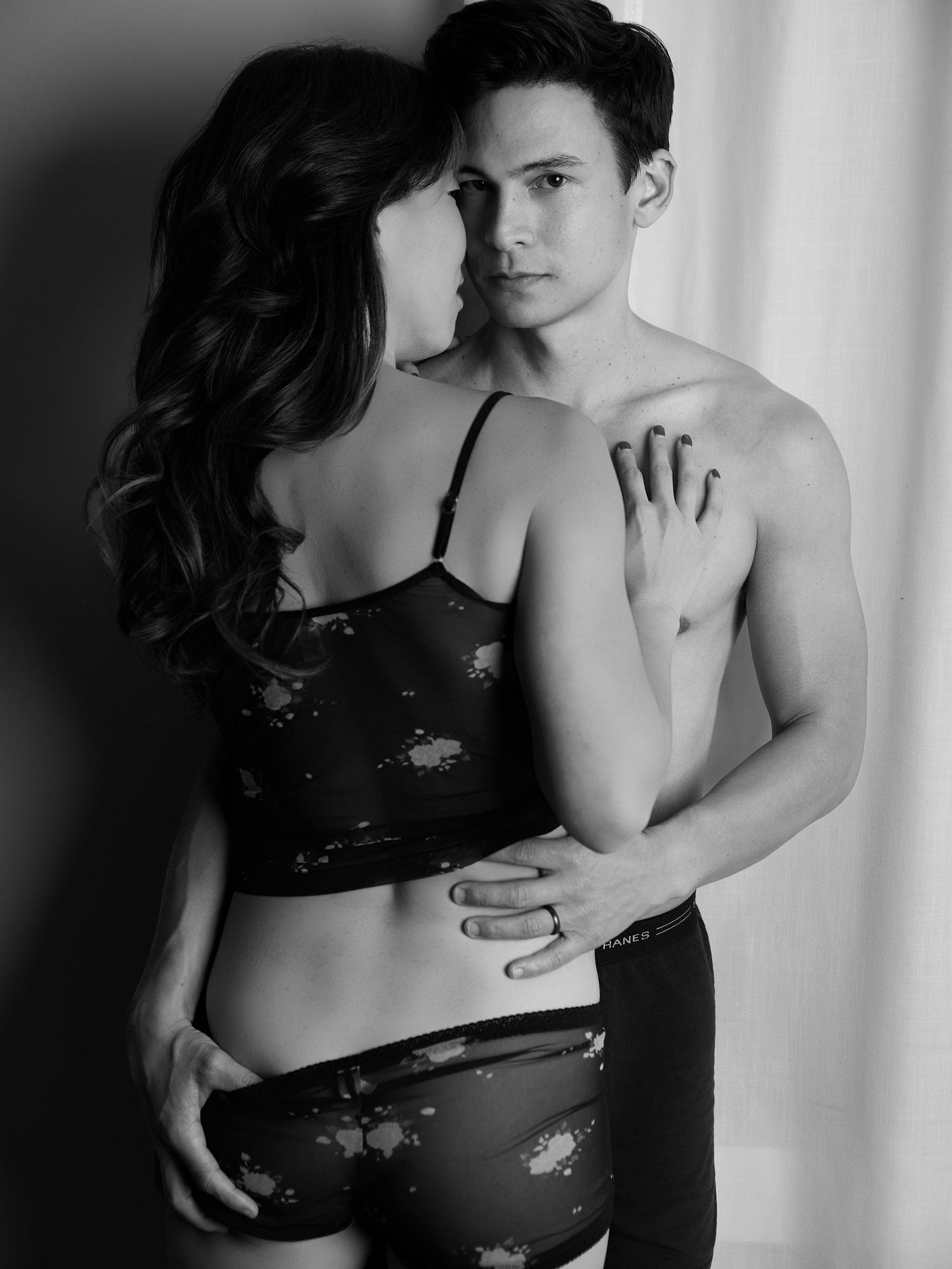 Sensual black and white couples boudoir showing intimate moments and gentle embraces.