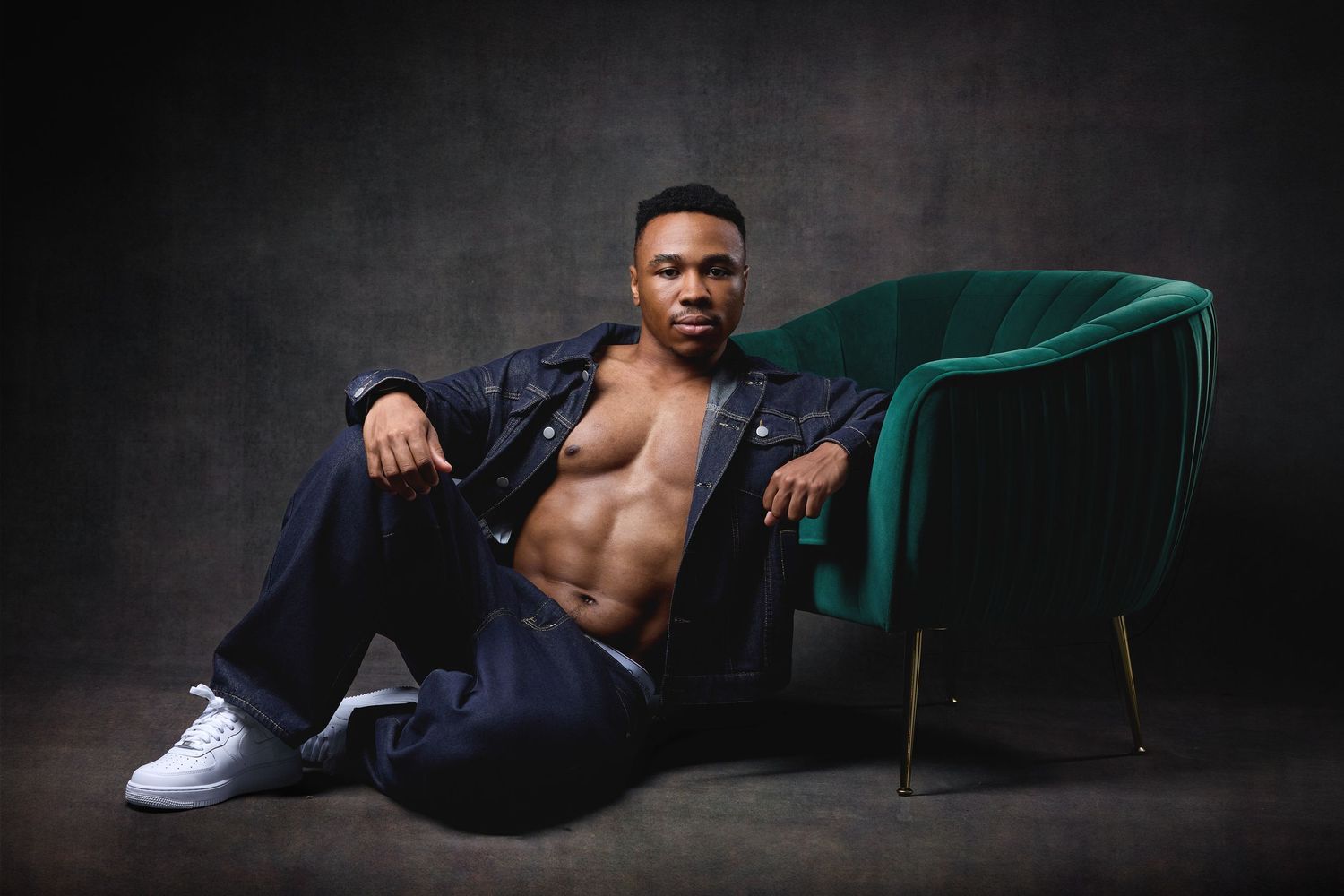 Studio portrait of a man showcasing physical form, strength, and male boudoir styling in Charlotte, NC.