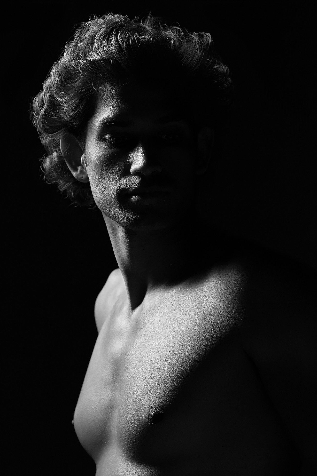 Male boudoir photography in Charlotte, NC, featuring soft, sophisticated posing on a luxury textured backdrop.