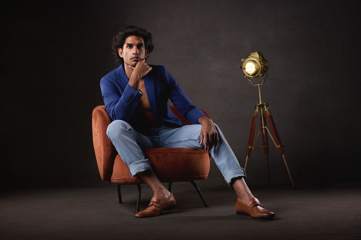 Luxury male boudoir photography in Charlotte featuring editorial lighting and professional posing in a studio setting.