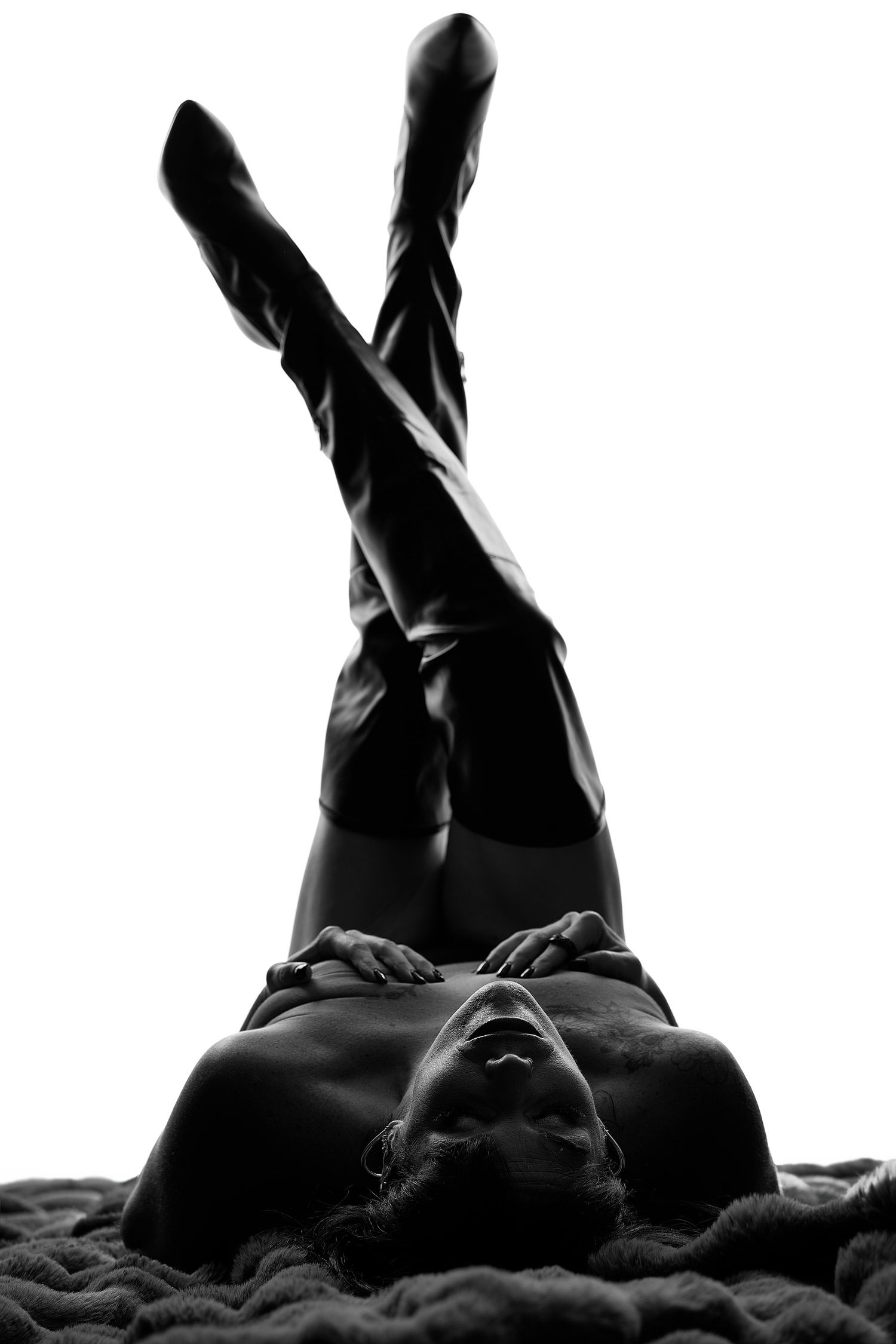 High-fashion black and white boudoir portrait focusing on dramatic shadows and sculptural form in Concord, NC.