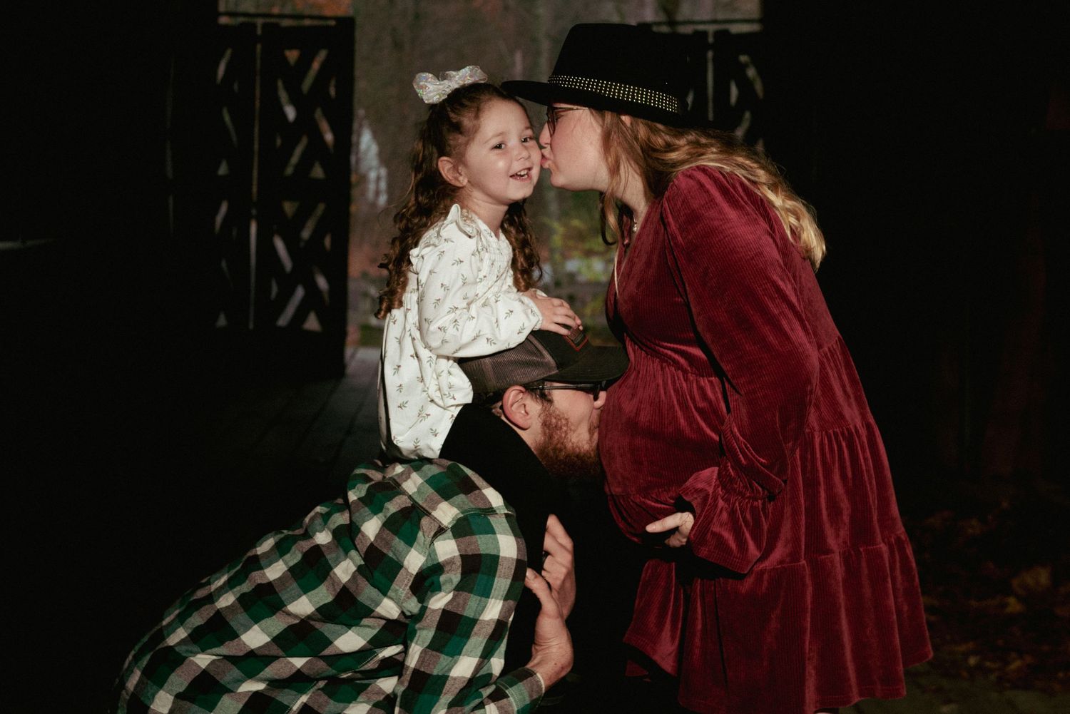 Intimate scene captured in dark lighting with vintage-style costumes.