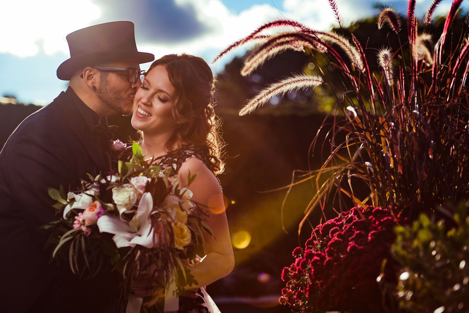 Sunset wedding photography with dramatic lighting and natural outdoor backdrop.