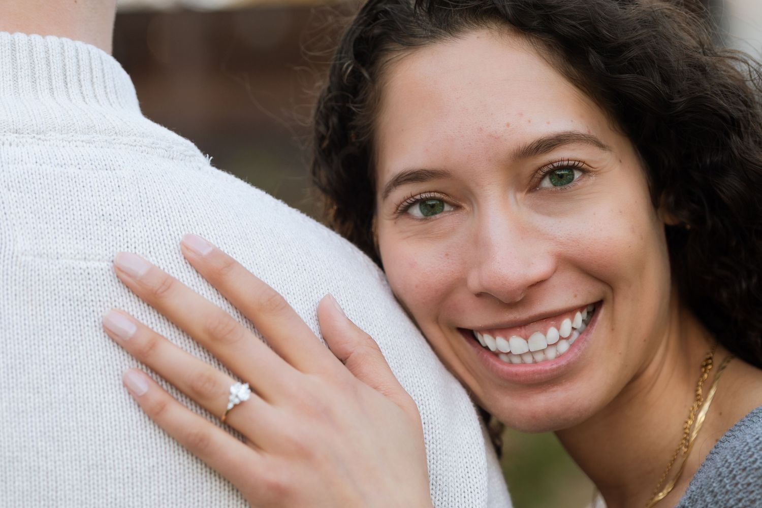 Close-up shots showcasing joyful expressions and a sparkling engagement ring.