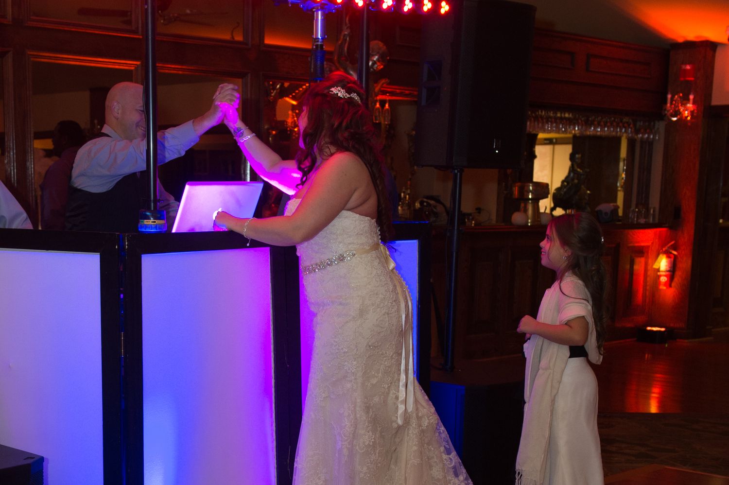 Wedding venue decorated with dramatic red and blue lighting creating an intimate atmosphere.