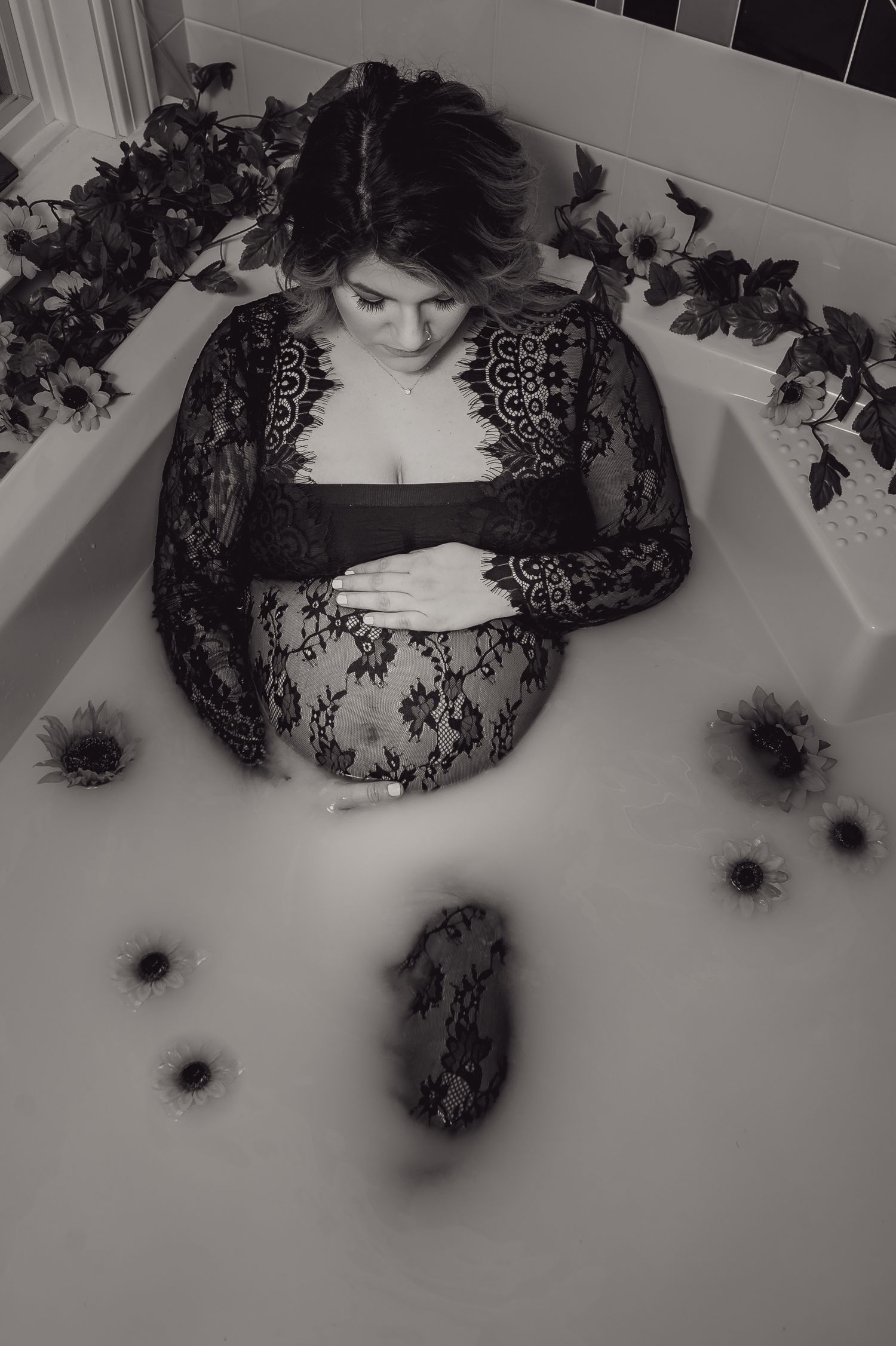 Artistic black and white boudoir photography with lace and dramatic lighting.