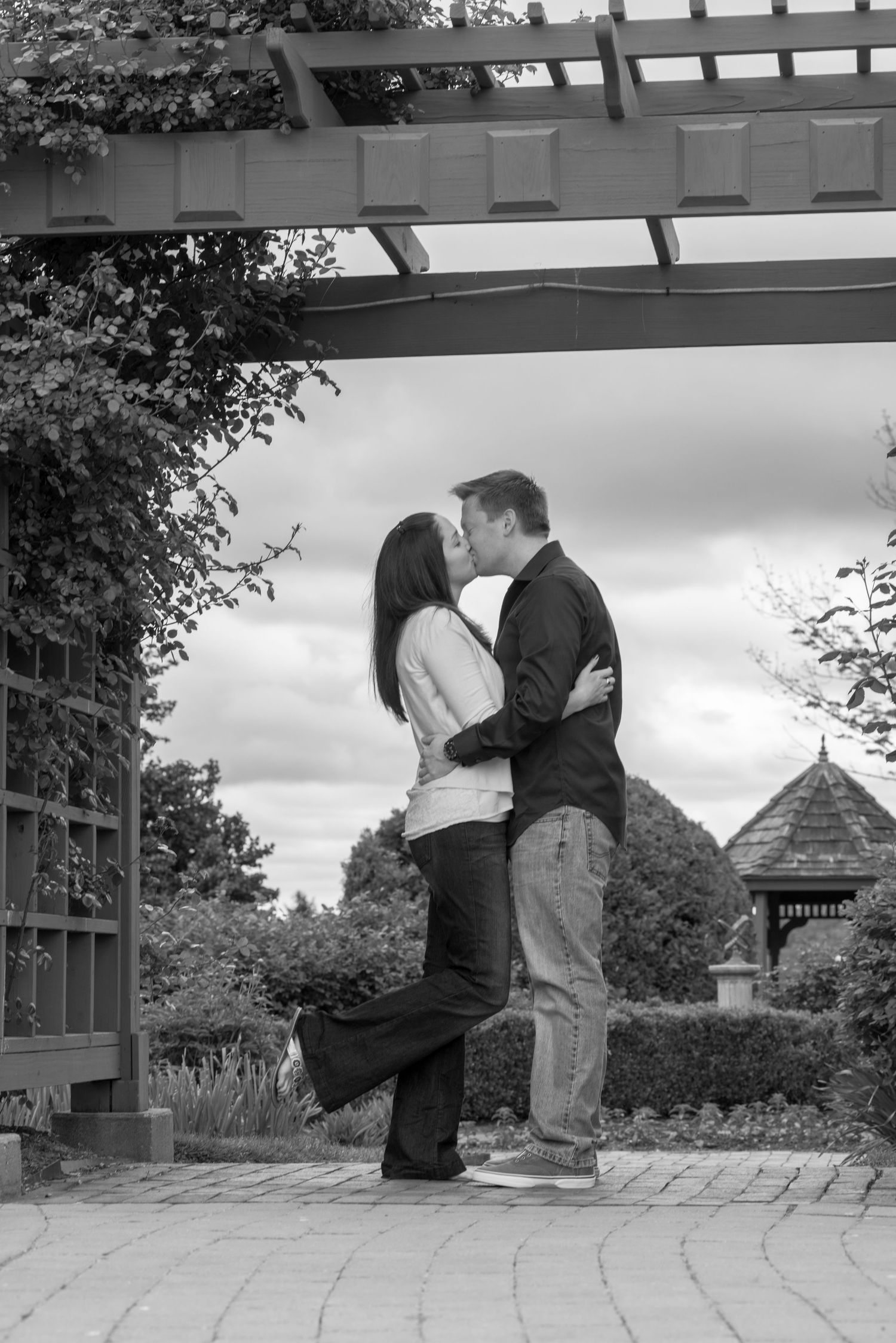 Romantic engagement photo sequence under pergola showing couple's intimate moments.