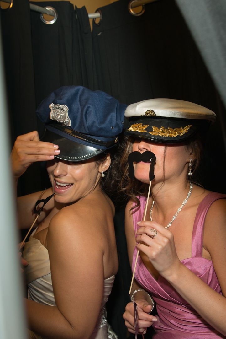 Group wearing nautical themed party props and captain hats posing together.