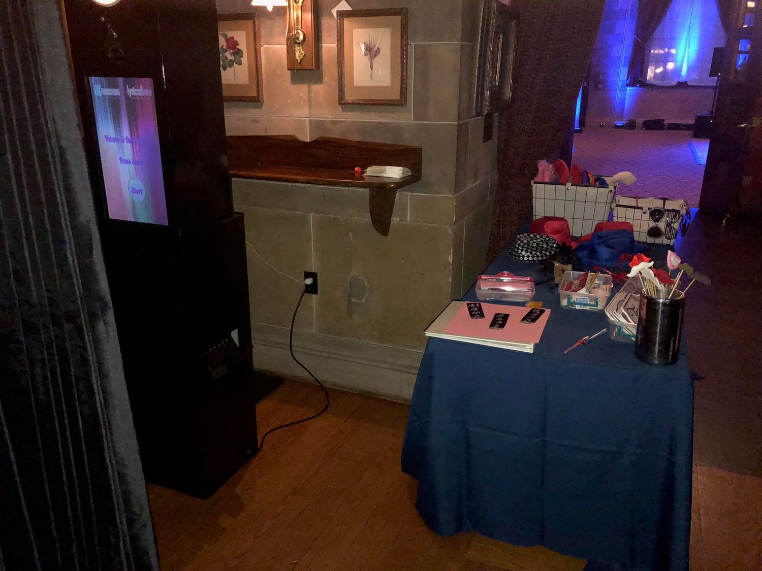 Professional DJ setup with blue accent lighting in a dimly lit indoor venue space.