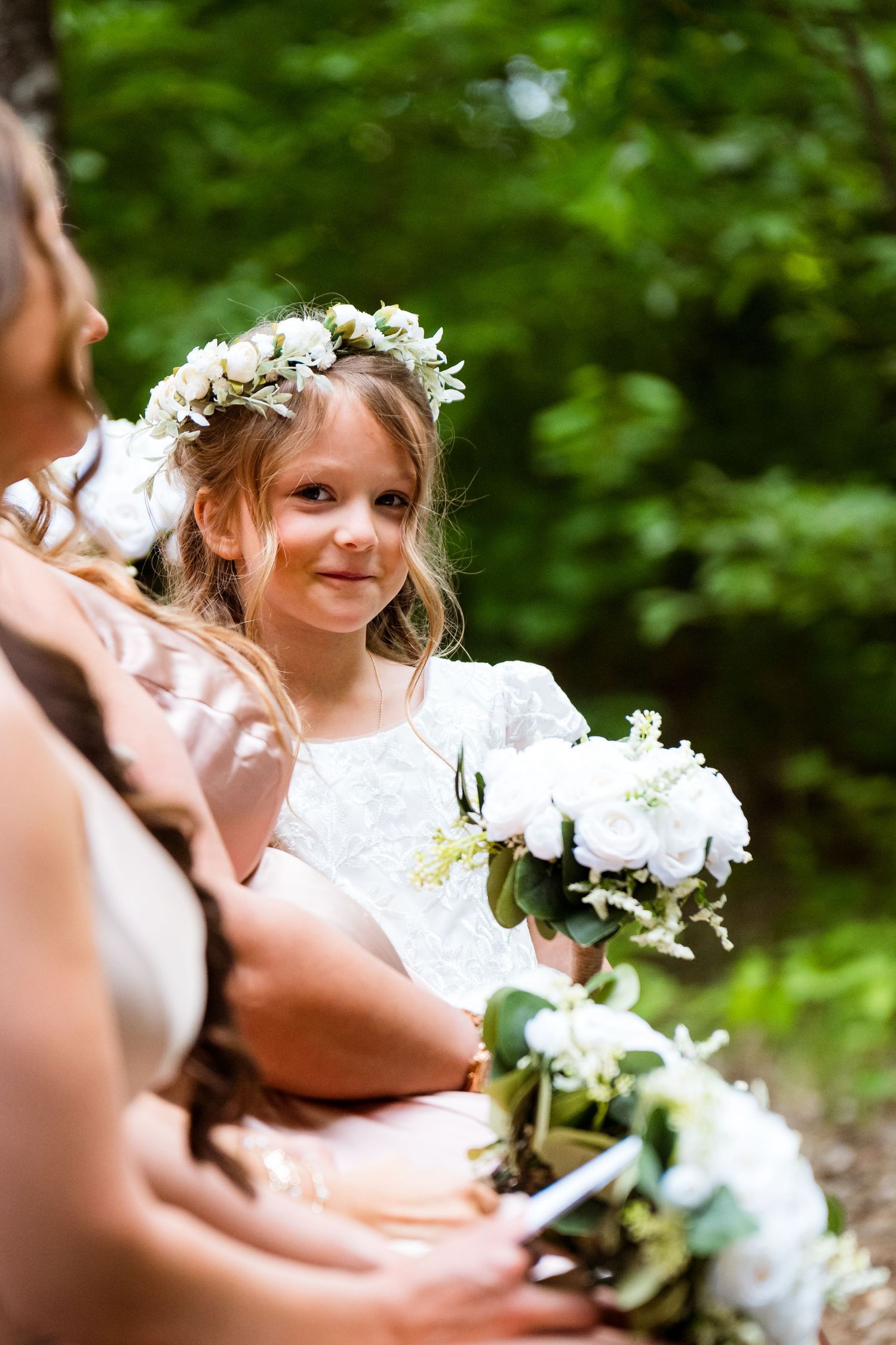 White floral arrangements and decorations in an outdoor wedding setting.