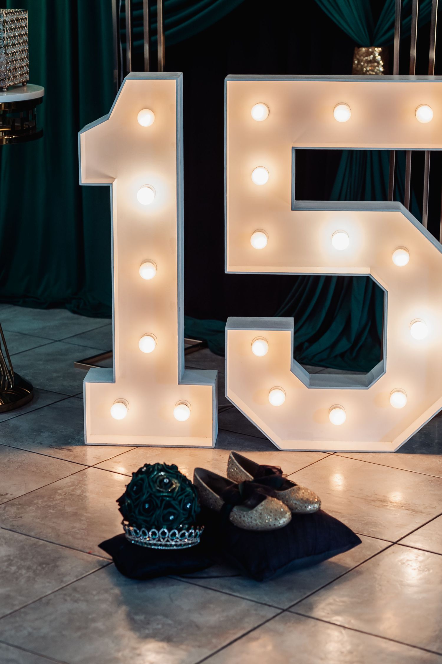 Illuminated marquee letters create romantic ambiance against dark backdrop.
