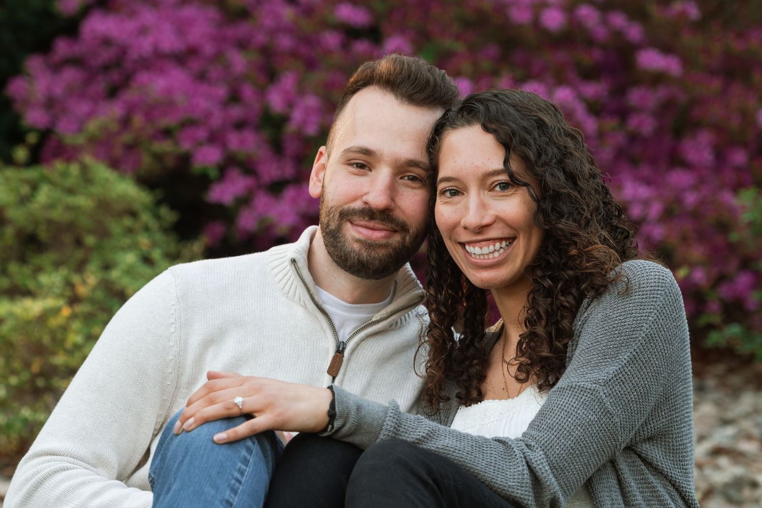 Spring engagement photos with vibrant pink azalea flowers in the background.