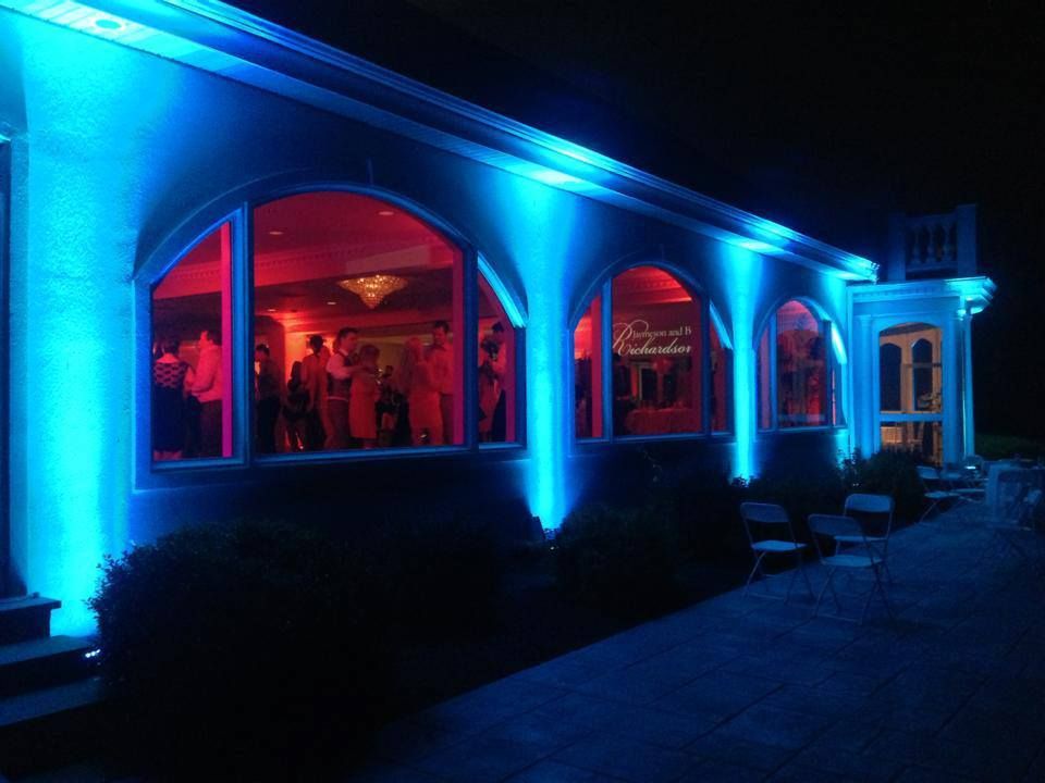 Architectural columns and arches illuminated with dramatic blue and red lighting effects.