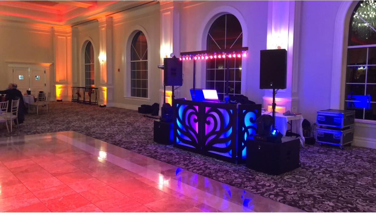 Event venue with dramatic red and purple LED lighting creating an elegant atmosphere.