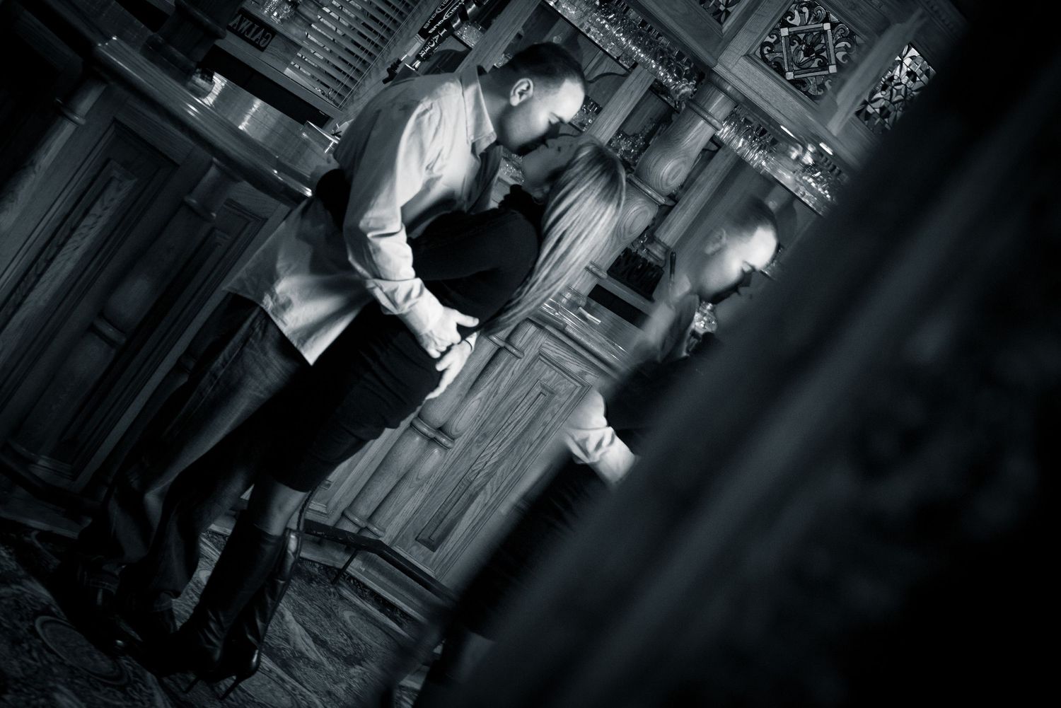 Dramatic black and white wedding photos captured in an elegant ballroom setting.