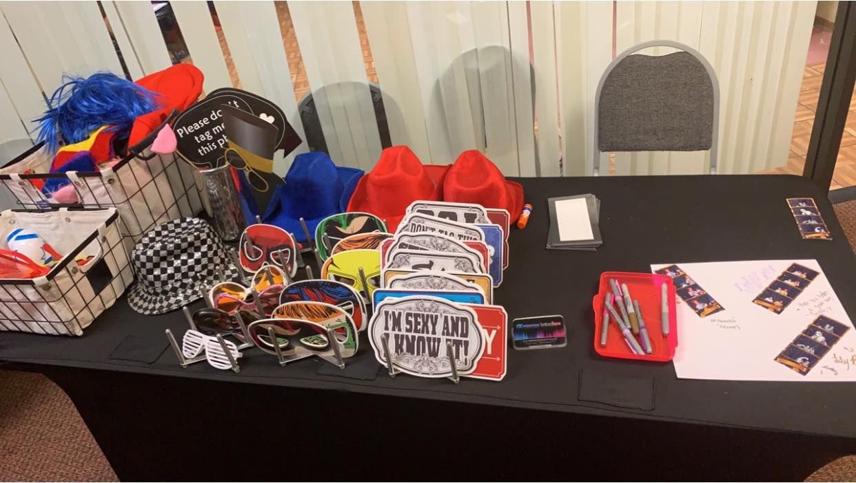 A table display with various merchandise items including t-shirts and promotional materials laid out for sale or display.