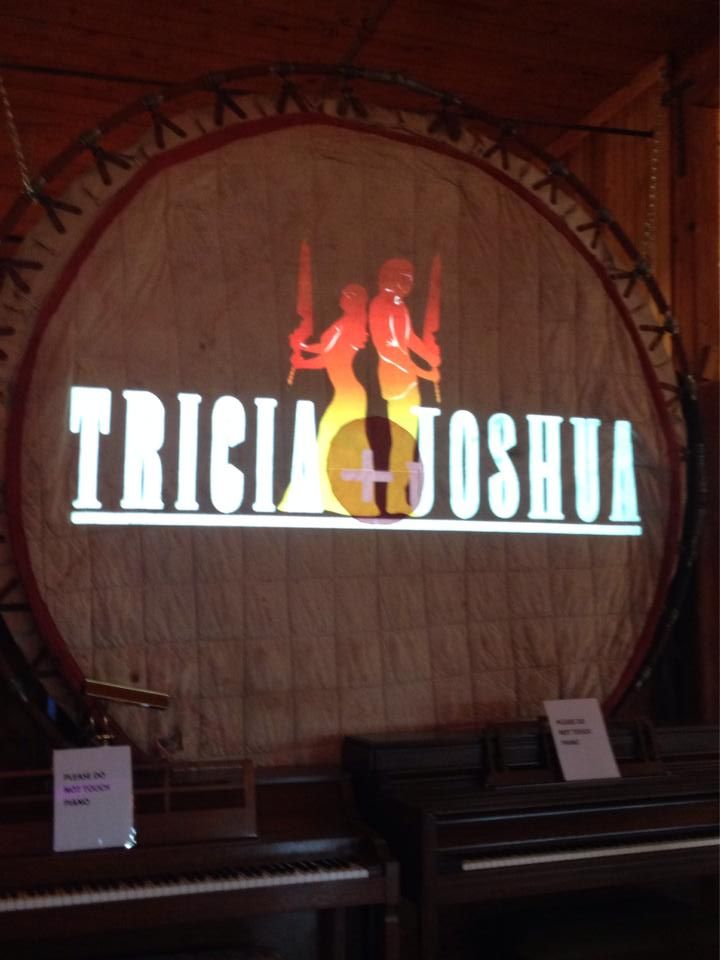 Illuminated text projection display on a curved wall with dramatic lighting effects.
