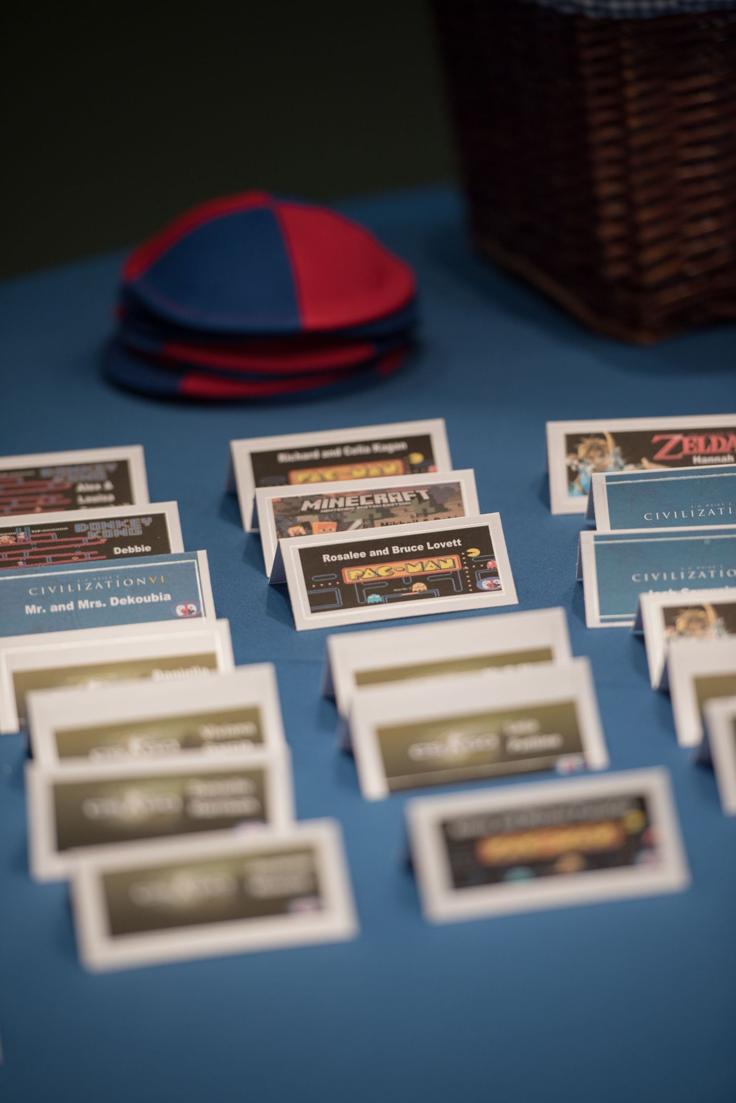 Row of place cards arranged neatly on a blue table at an event.