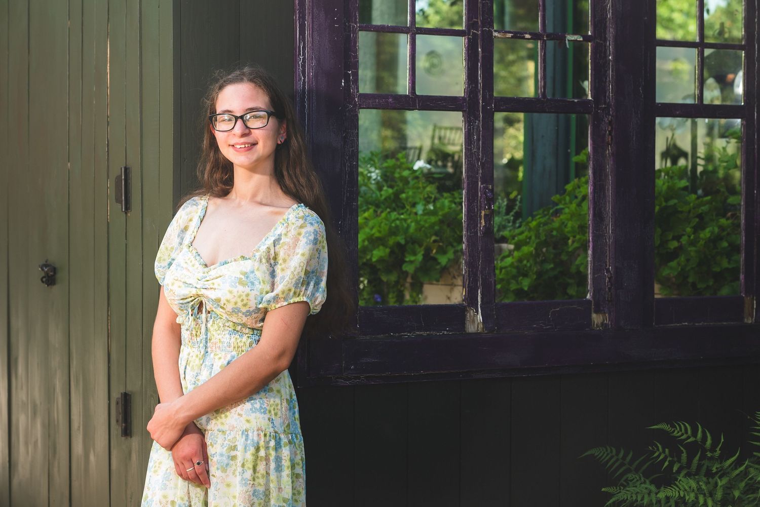 Vintage-style photo shoot location with green wooden walls and large windows.