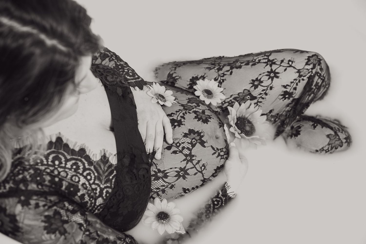 Artistic black and white composition of lace fabric floating in cloudy water.