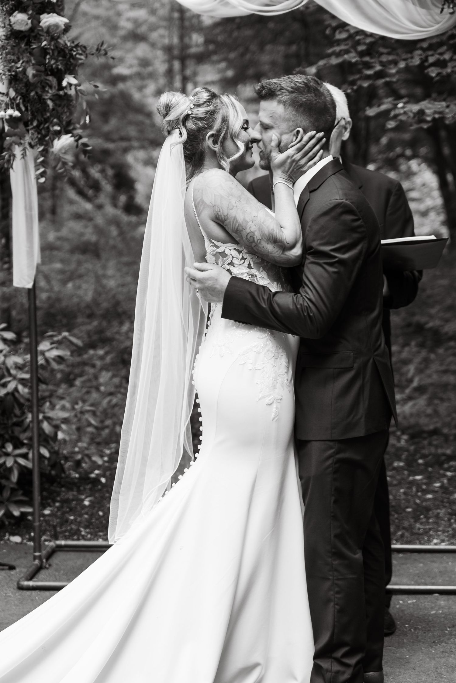 Wedding ceremony sequence showing couple exchanging vows under white drapes in a forest setting.