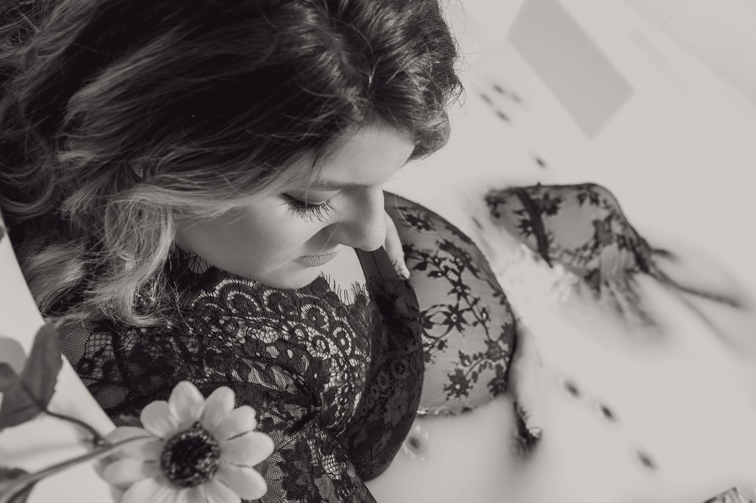 Black and white artistic photograph featuring flowing fabric in milky water.
