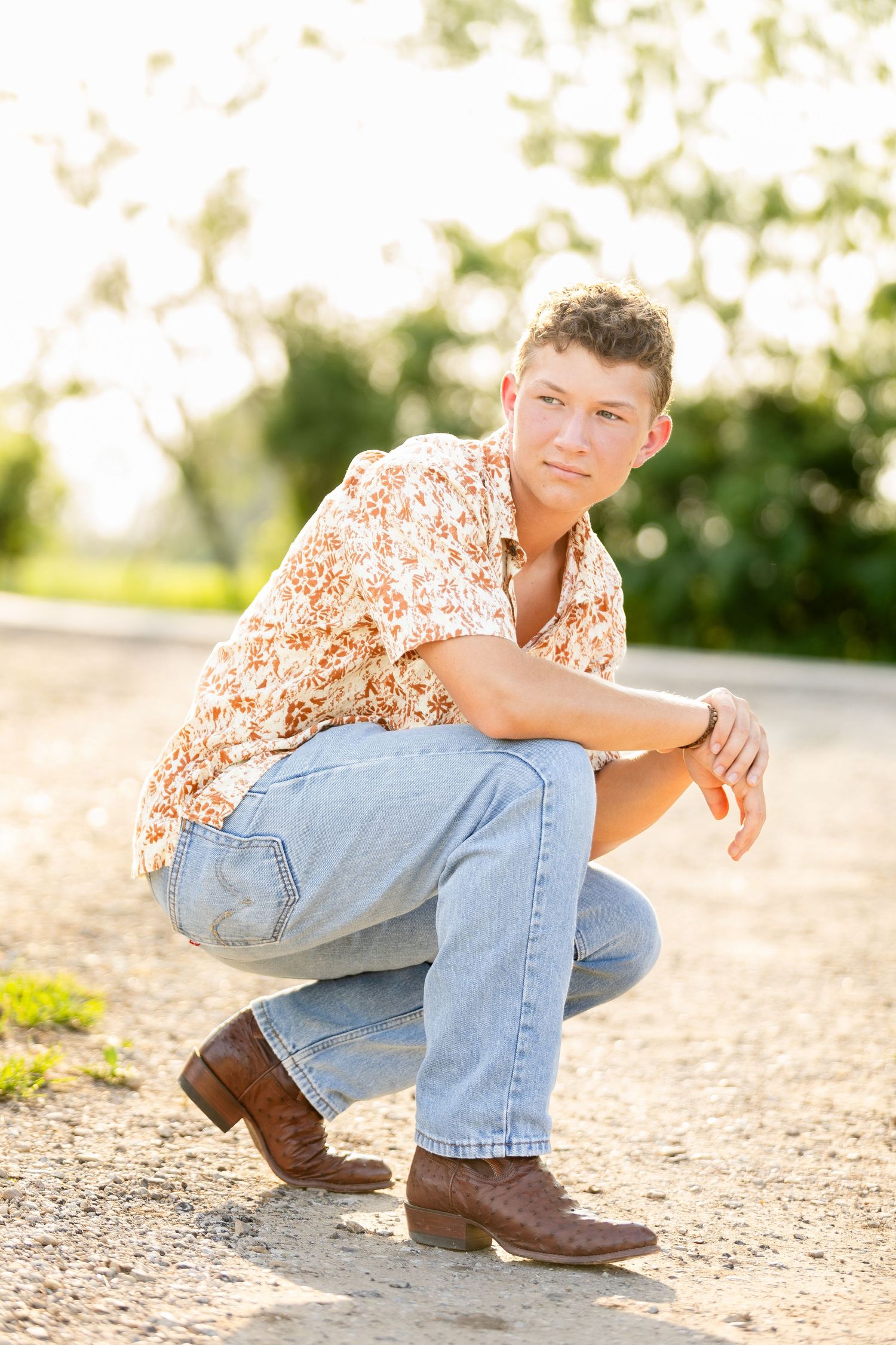 High School Senior Portrait of a grad in jeans and cowboy boots during golden hour by Bella Priscilla Photography in New Braunfels Texas