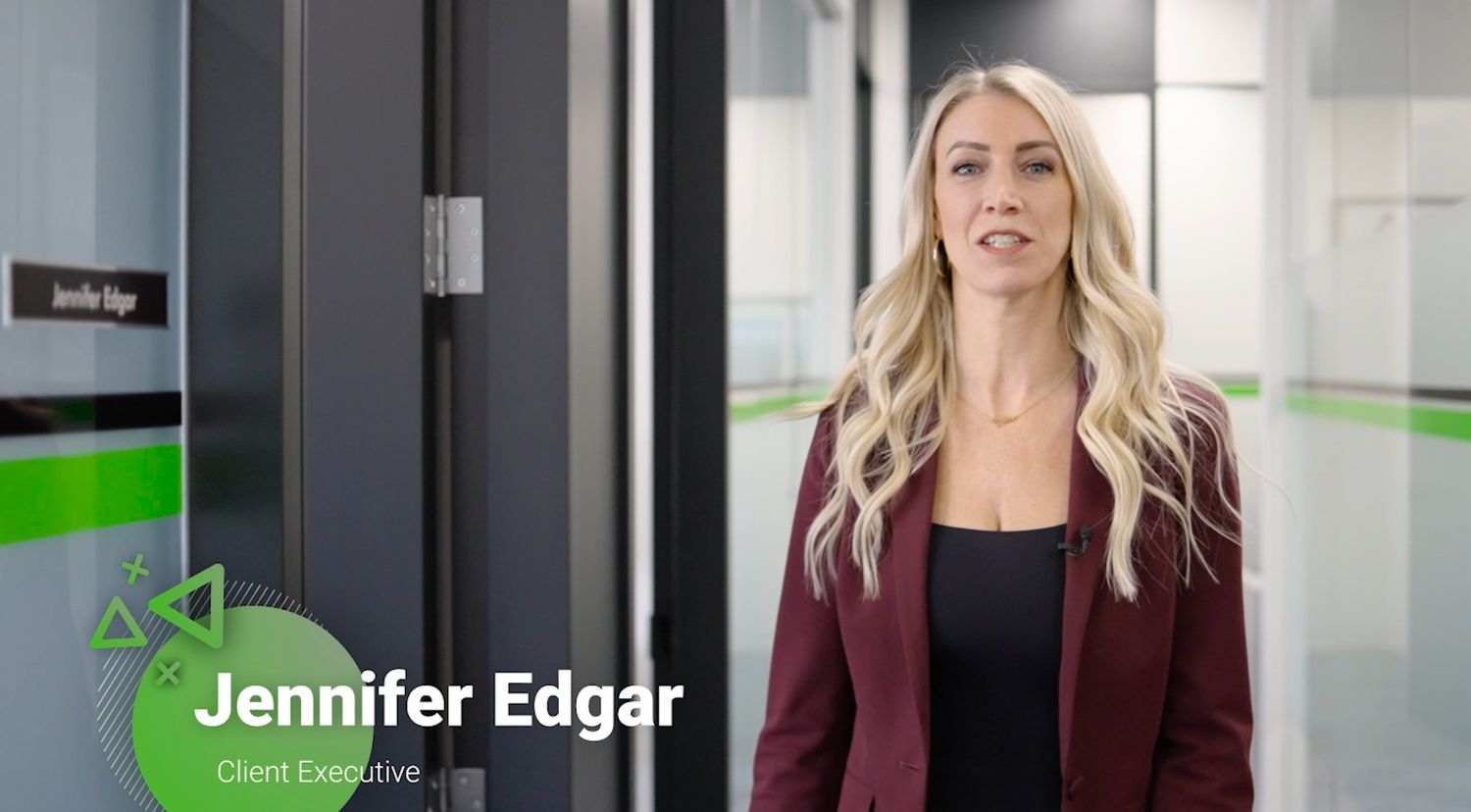 Corporate professional speaking in modern office setting with green accents.