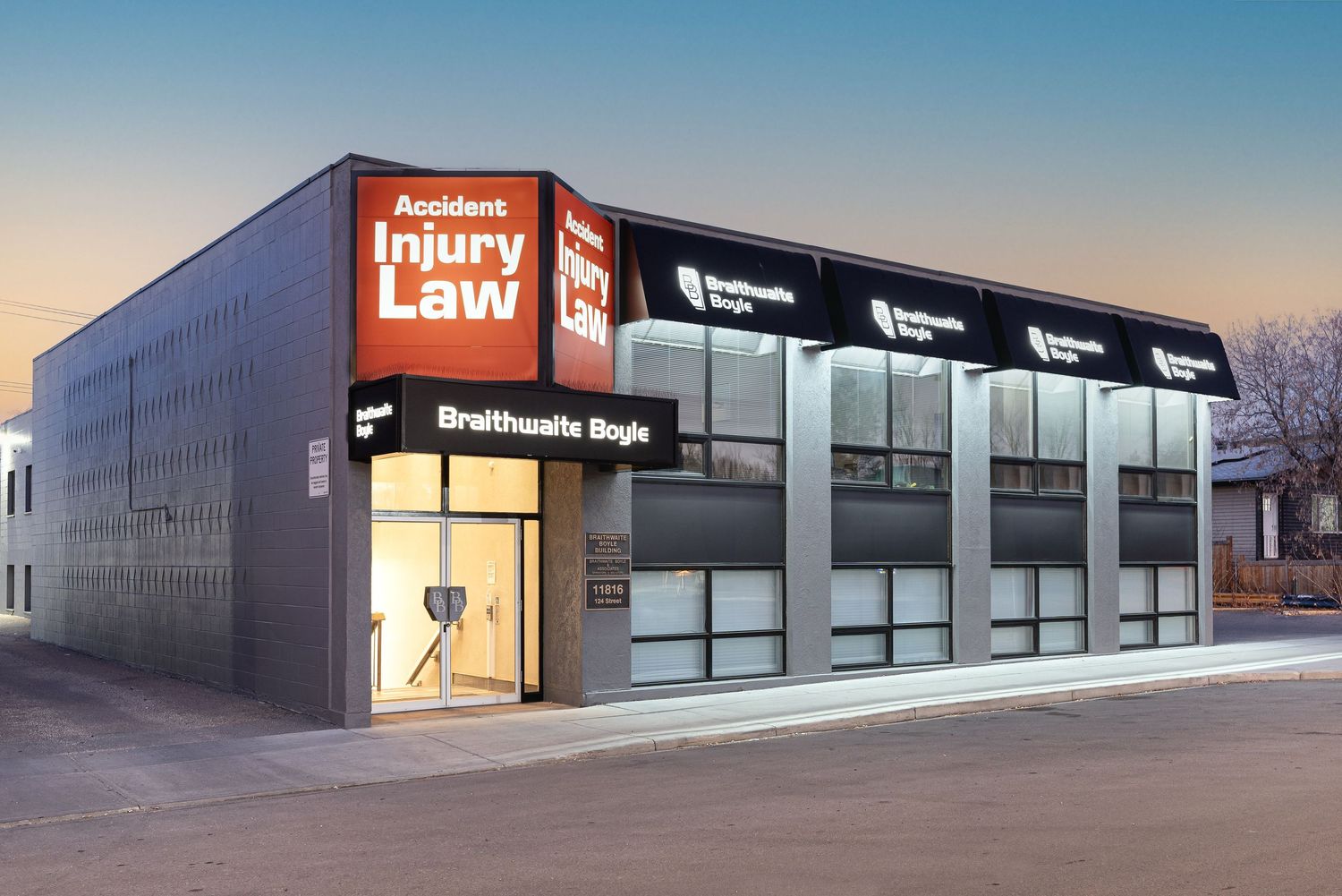 Modern dental office exterior with illuminated signage at dusk showing multiple connected retail units.